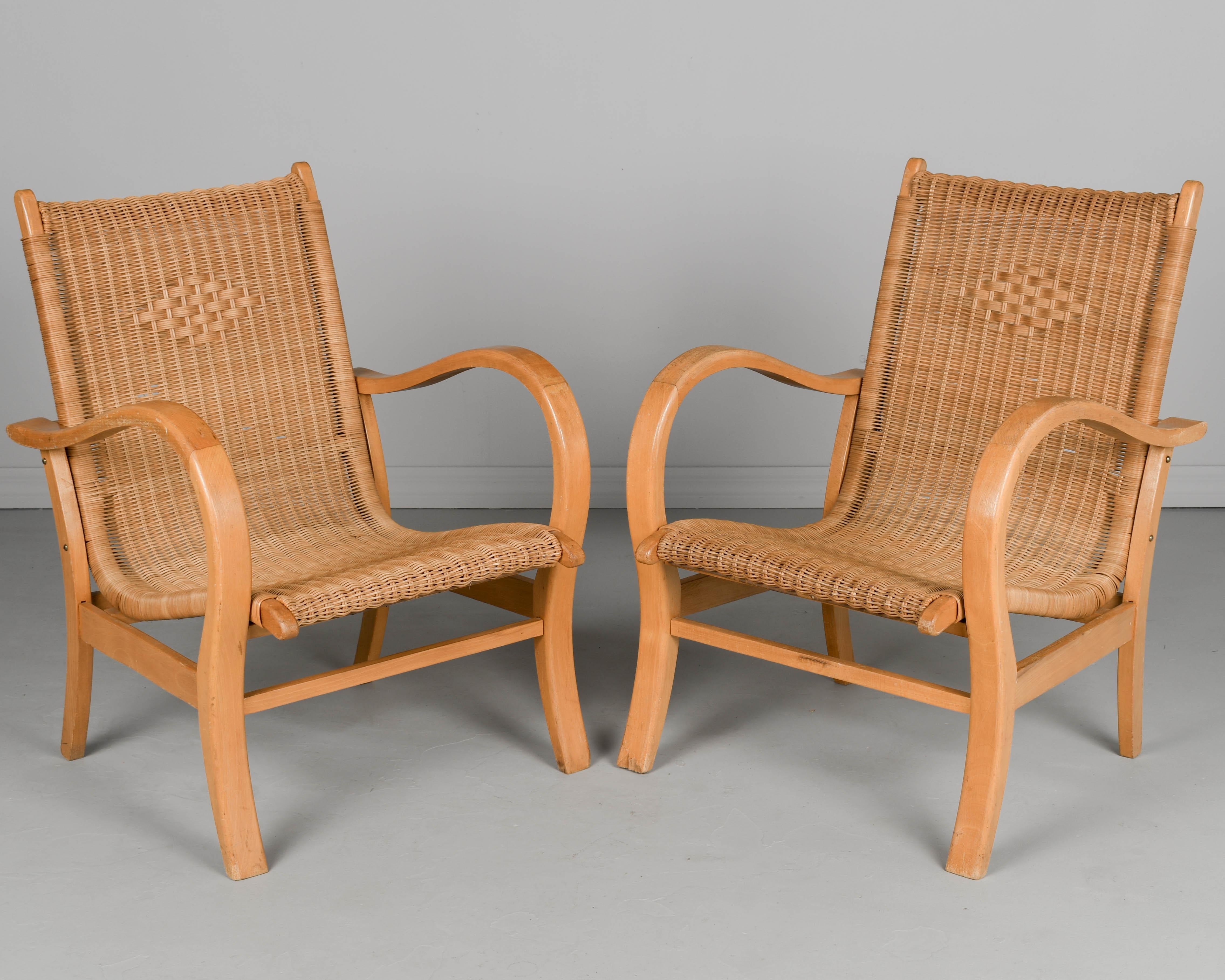 A pair of vintage Art Deco Bauhaus lounge chairs by Berlin born designer Erich Dieckmann (1896-1944). Sturdy bent beech wood frame with tightly woven wicker seat and back. Decorative weaving on the seat back. Nice curved form and comfortable seating