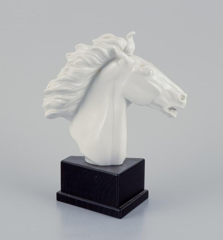 Erich Oehme (1898-1970) for Meissen, Germany. 
Porcelain sculpture in the form of a horse's head. Blanc de Chine.
Mid-20th century.
Perfect condition.
Marked.
Fourth factory quality.
On a black-painted wooden base.
Dimensions: Height 22.5 cm x