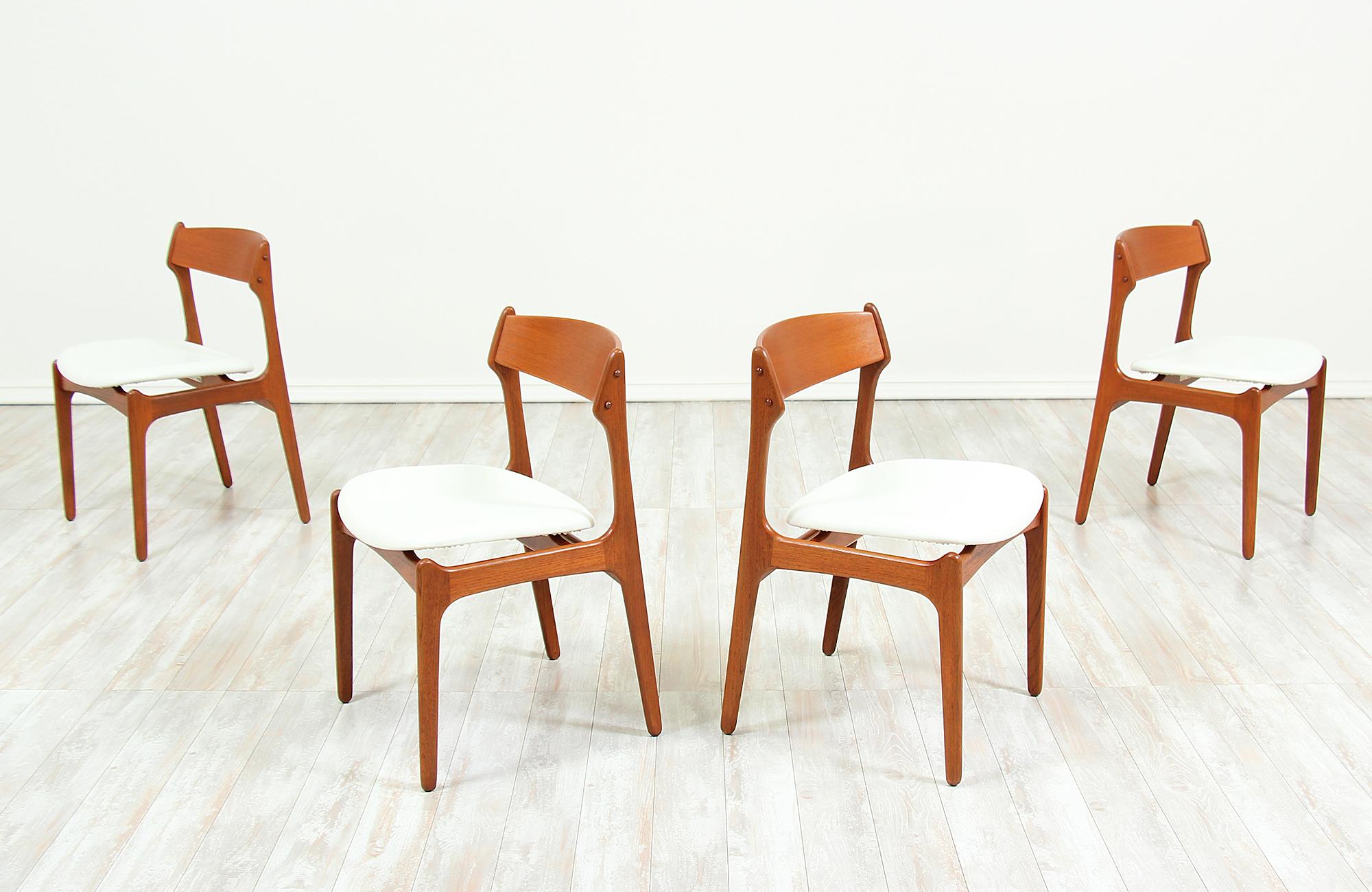 Set of four dining chairs designed by Erick Buch for O.D. Møbler in Denmark, circa 1960s. The frame is made of solid teak wood with the seats newly upholstered in full-grain white leather, which complements the light teak wood tone. The chairs have