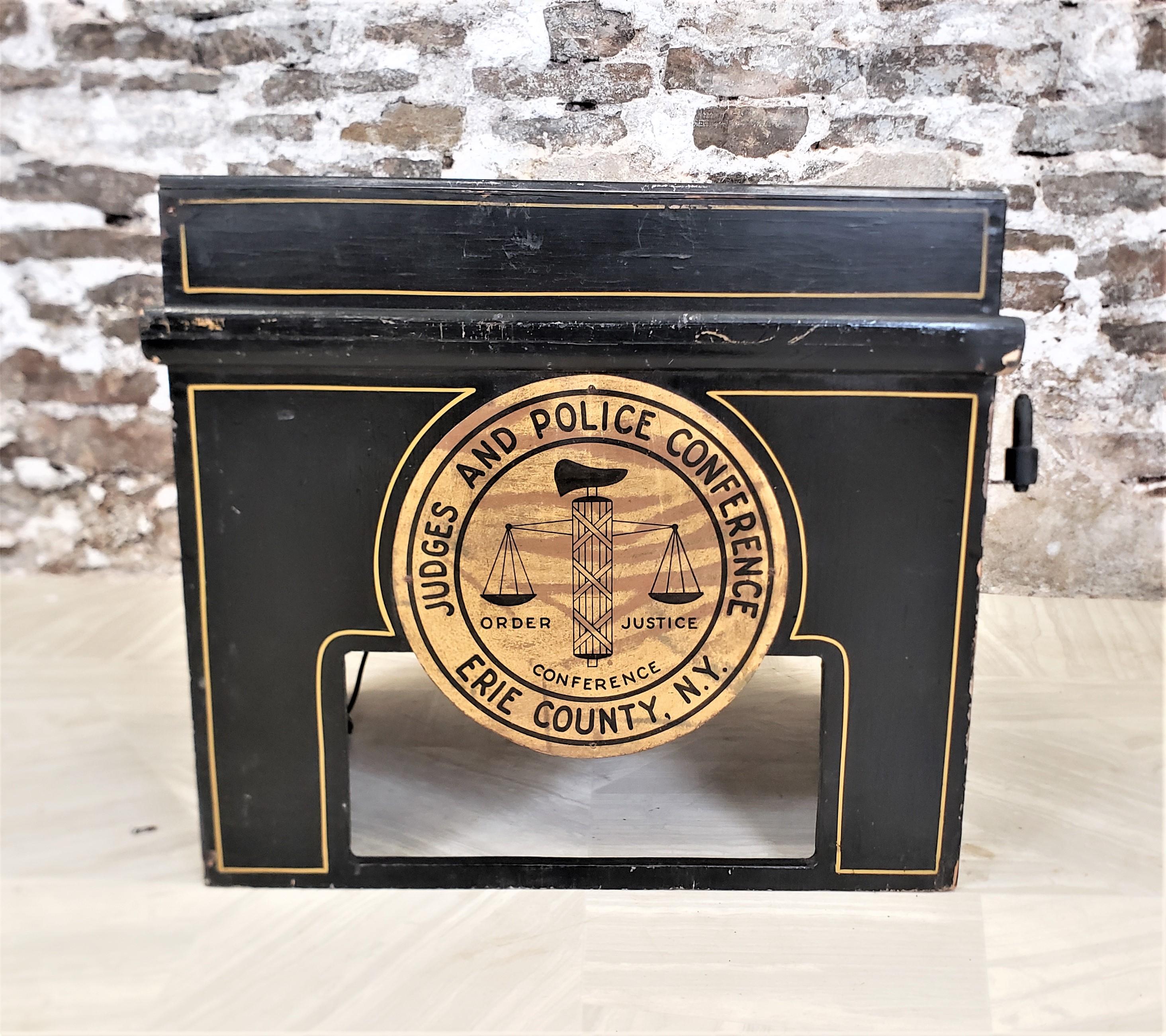The maker of this lecturn is unknown, but presumed to have originated from the United States and date to approximately 1965. The podium is composed of pine boards and playwood with hinged sides and top and has been painted black with gilt accents.