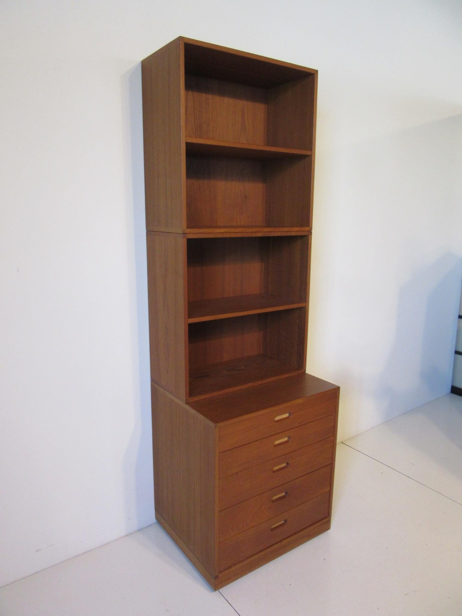 A solid teak three piece smaller scaled bookcase with adjustable shelves and five drawers with leather inserts to the pulls . This well made piece was purchased in 1962 by the original owner who lovingly cared for this piece until their recent