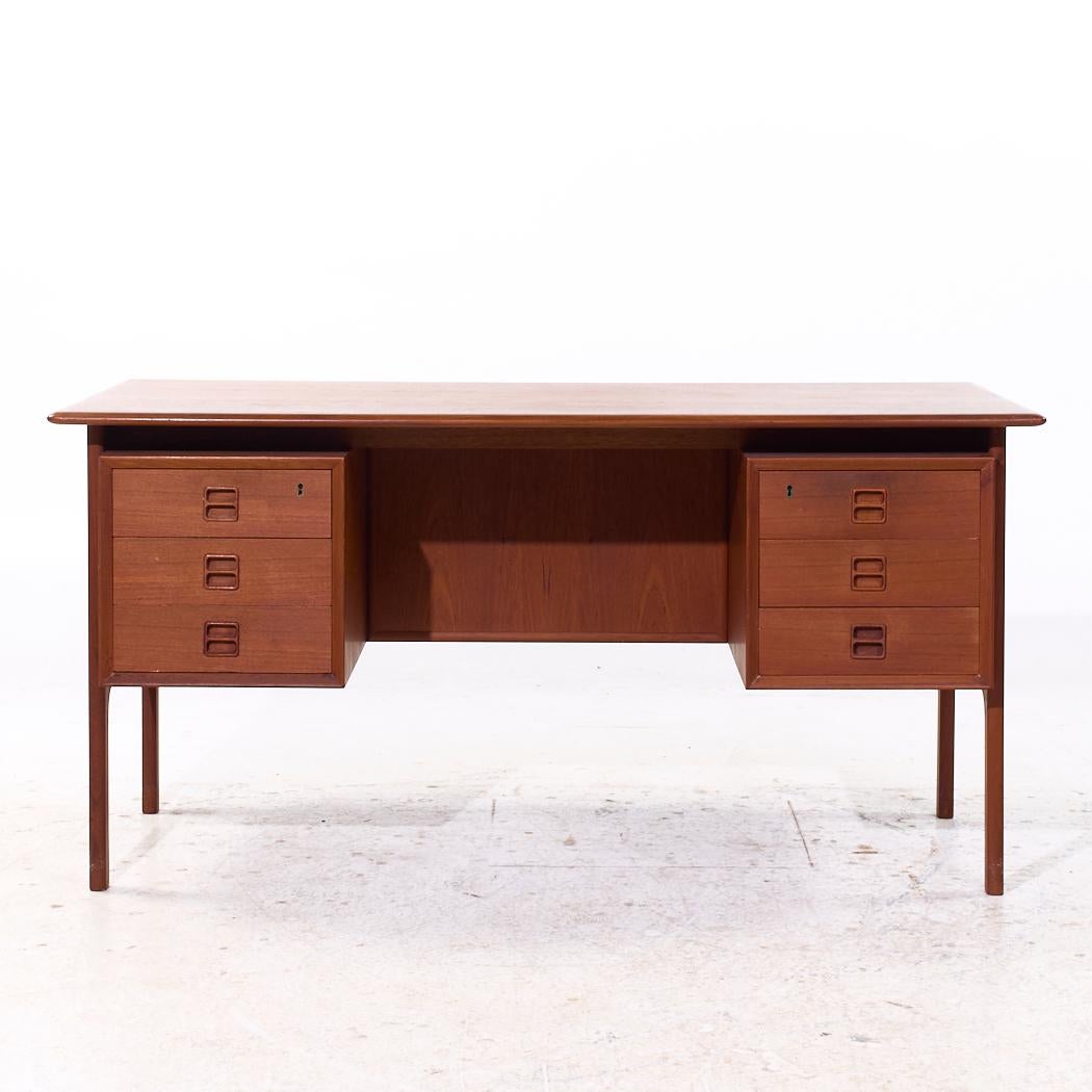 Erik Brouer for Brouer Møbelfabrik Mid Century Danish Teak Desk

This desk measures: 57 wide x 29.25 deep x 28.25 high, with a chair clearance of 27.5 inches

All pieces of furniture can be had in what we call restored vintage condition. That means