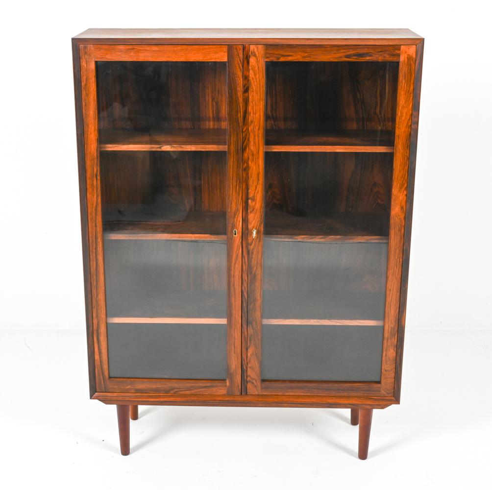 This captivating rosewood cabinet, designed by the celebrated Danish furniture maker Erik Brouer for Brouer Møbelfabrik in the 1960s, embodies the era's love for rich materials and sophisticated functionality. This piece is a fine example of the