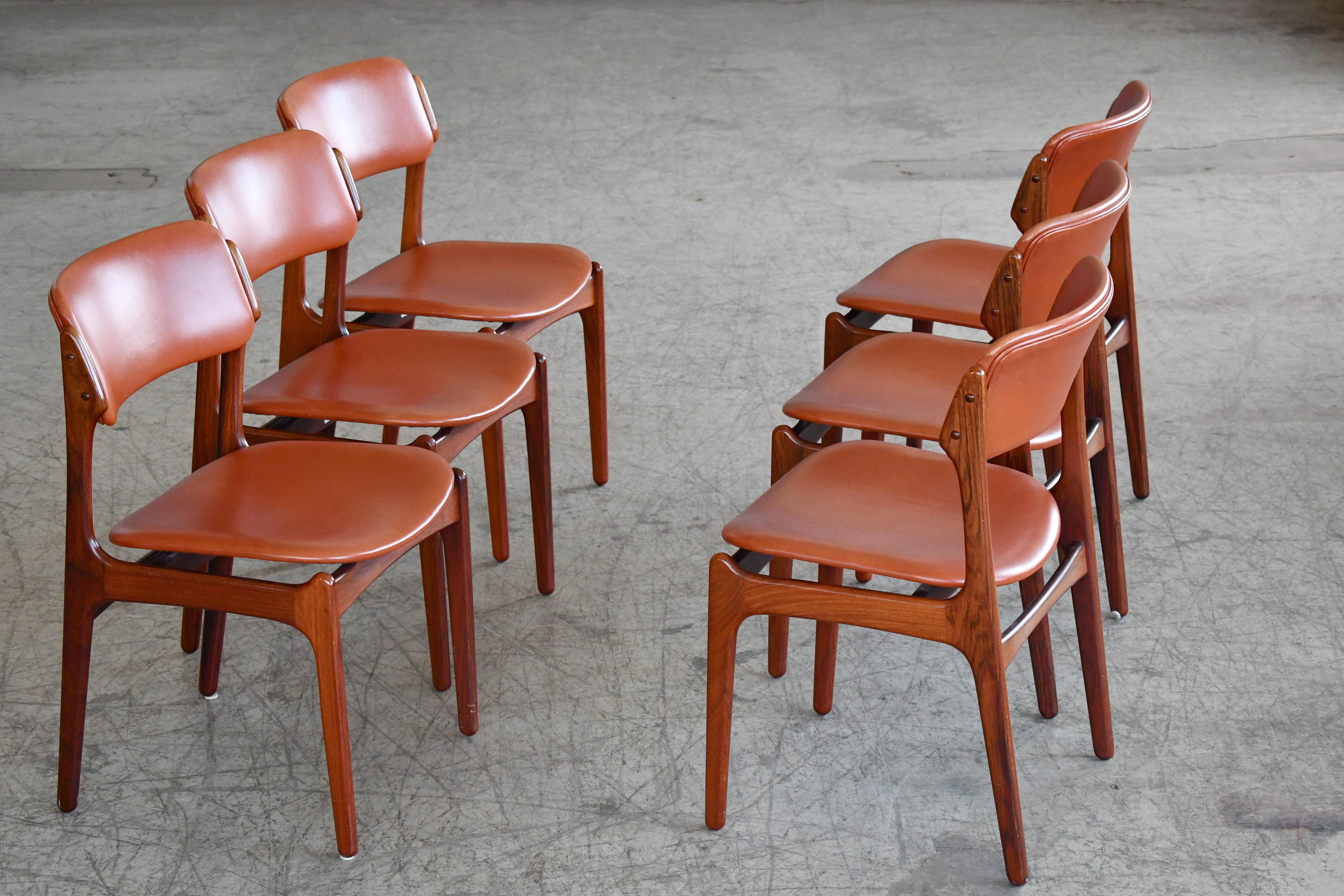 Beautiful set of six mid-century Danish dining chairs designed by Erik Buch for OD Mobler A/S, Odense Denmark, circa 1960s. Rosewood with leather seats. Simple yet elegant lines, comfortable seating experience and solid construction; and Erik Buch