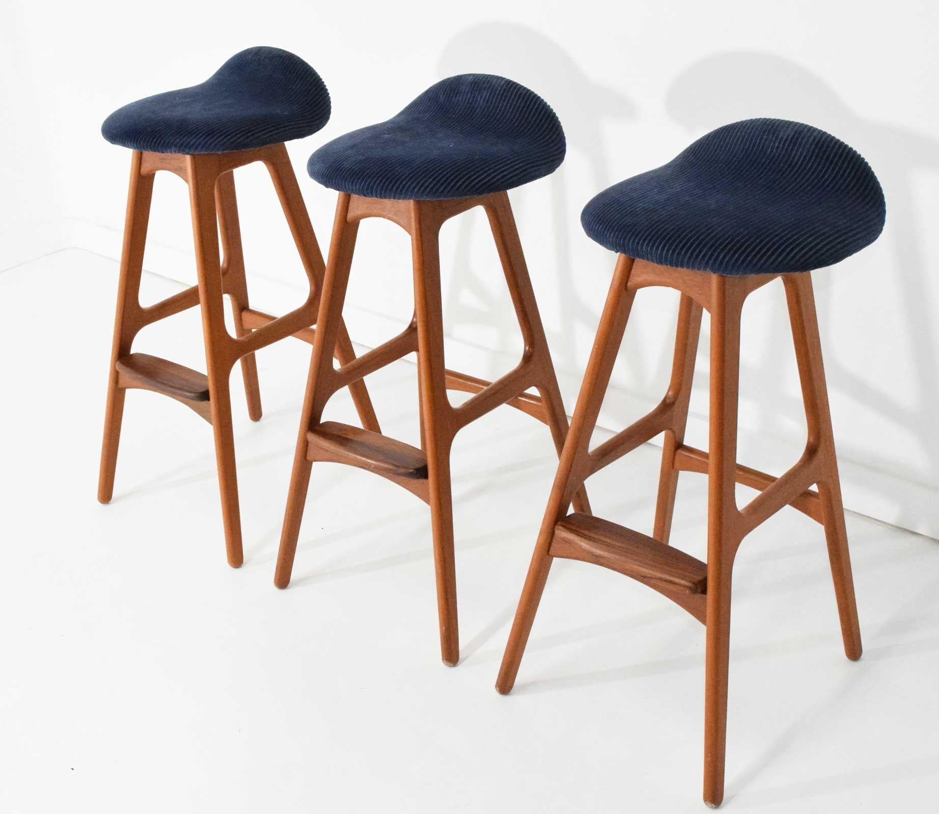 Iconic design by Erik Buch. Great looking bar stools in teak with blue corduroy seat cushions. Very easy to replace in fabric or leather of choose.