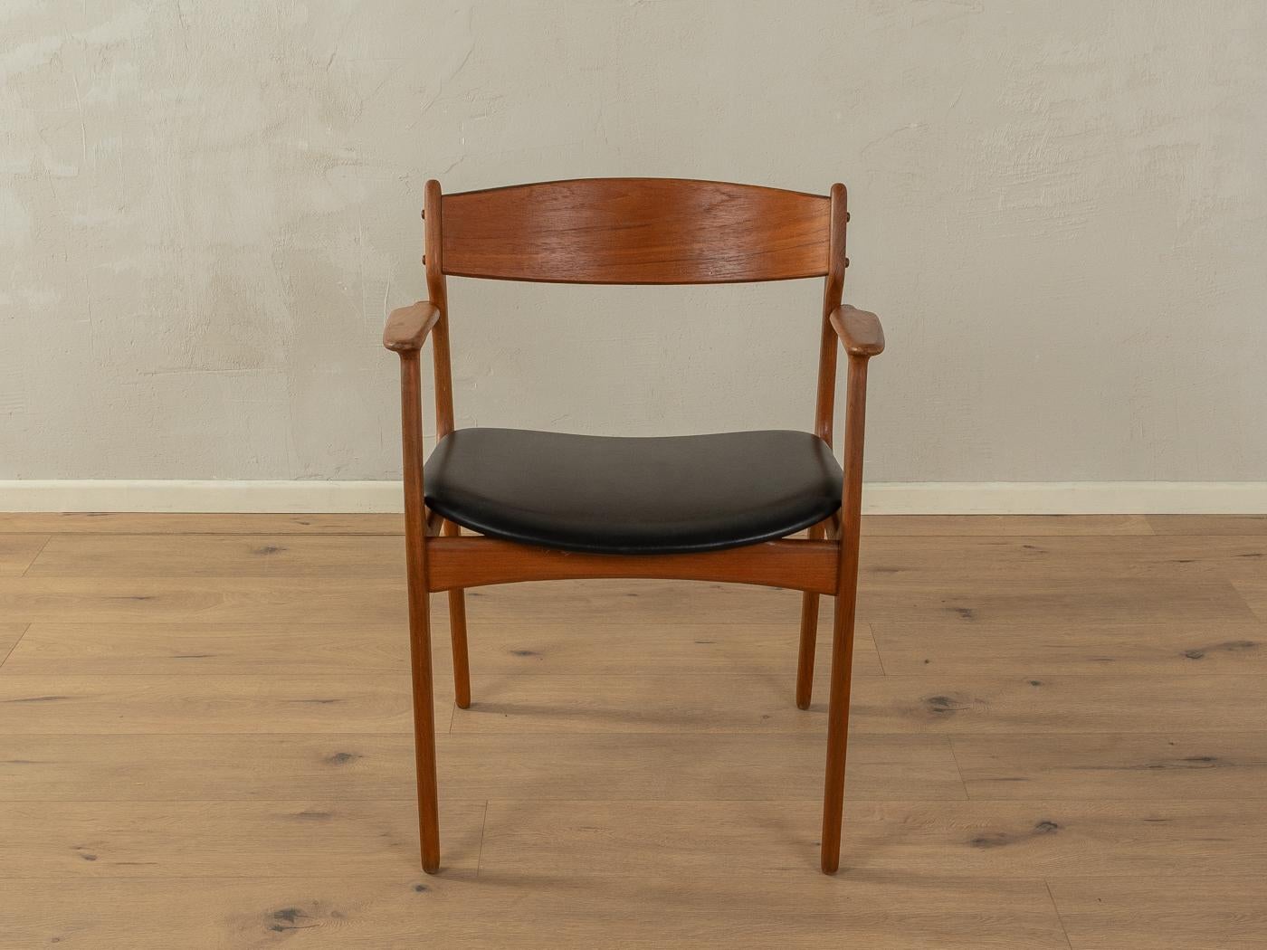 Classic armchair by Erik Buch with a teak frame and seat with original leather cover in black. Draft from 1954.

Quality Features:
    accomplished design: perfect proportions and visible attention to detail
    high-quality workmanship using