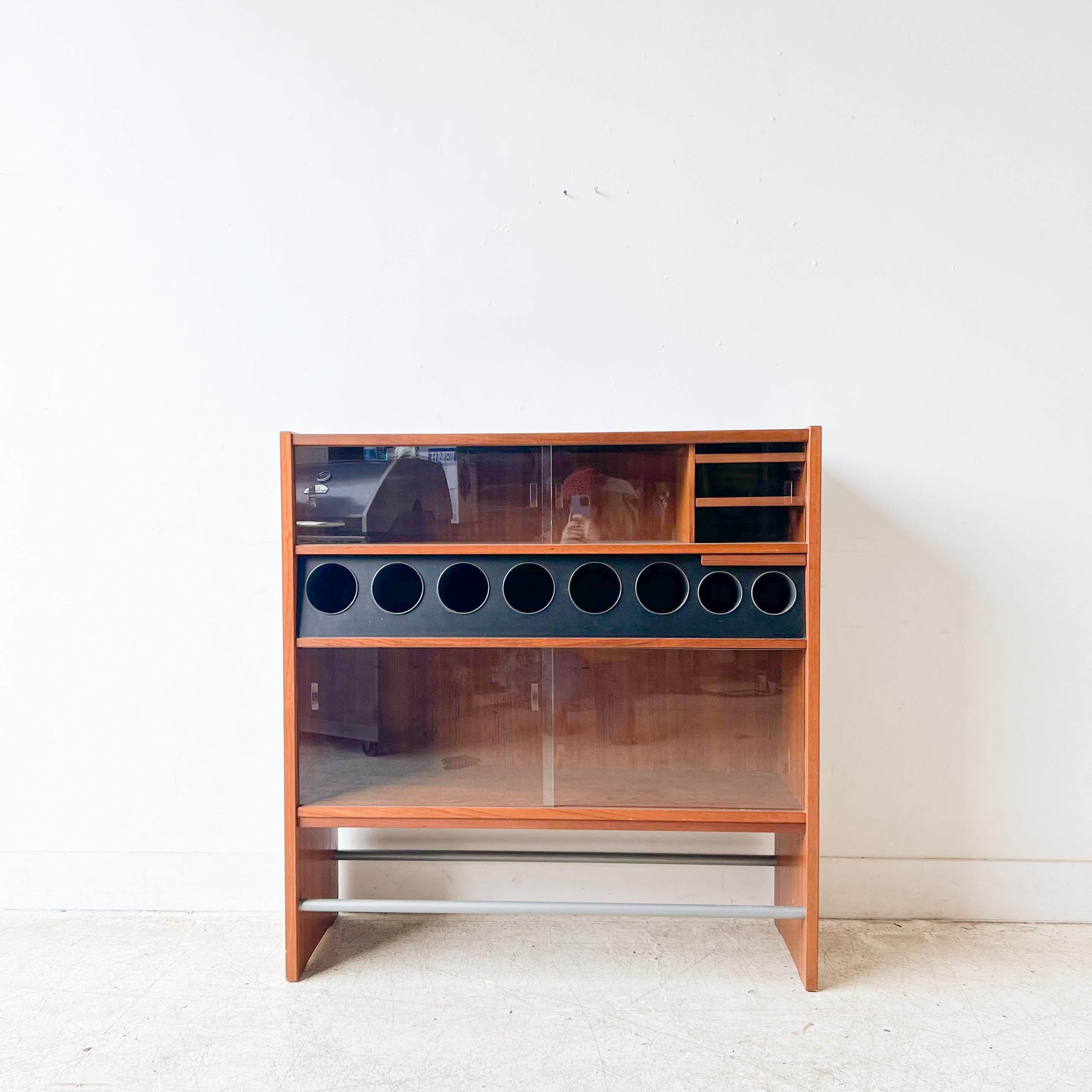 Mid-Century Modern Danish teak dry bar by Erik Buch. He was a Danish industrial designer that focused on the Scandinavian modern style. Buch’s organic and functional aesthetic resulted in furniture that spanned chairs, stools, and cabinets. Like