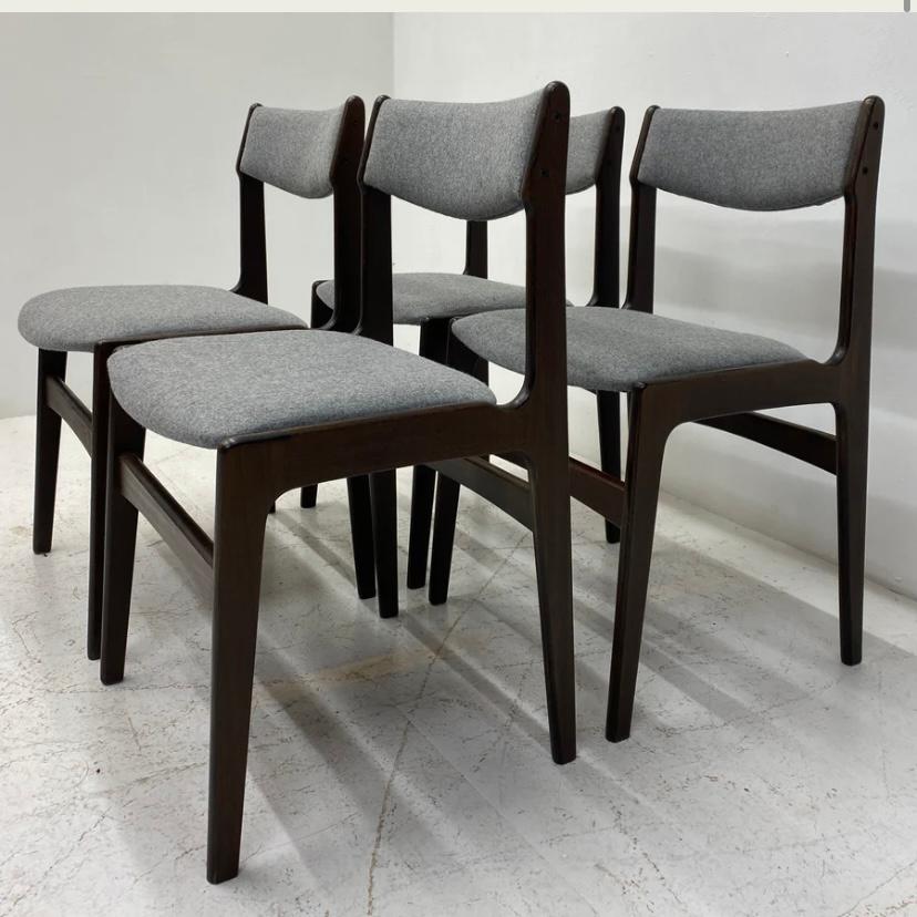 A set of four superb Danish midcentury dining chairs designed by Erik Buch. These dining chairs are highly desirable; & are the epitome of organic lines, tactile curves & stunning wood. The dining chairs are a solid dark wood to the frame & legs.