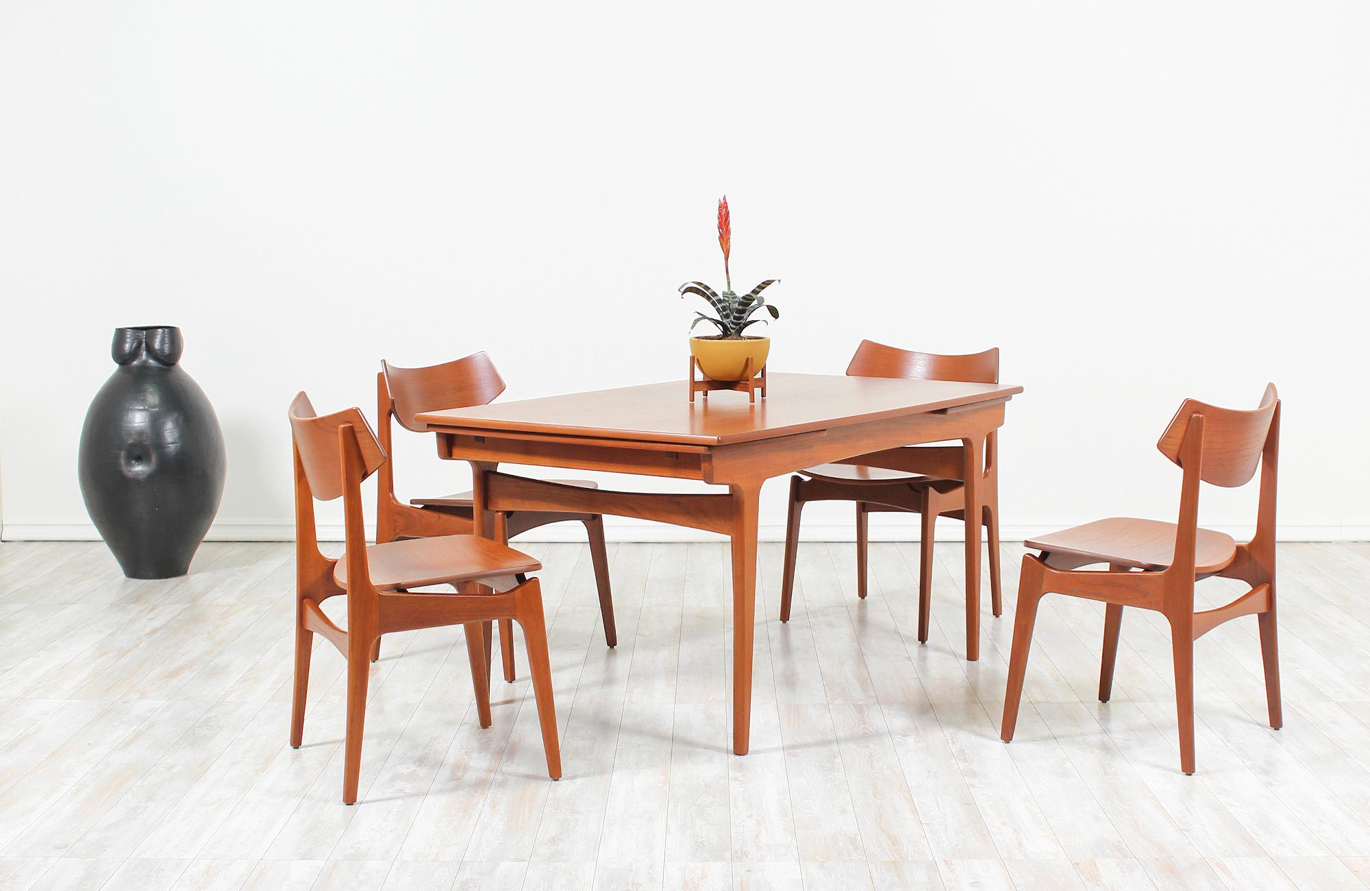 Set of four dining chairs designed by Erik Buch for Funder-Schmidt & Madsen in Denmark, circa 1960s. A dynamic Danish modern set of dining chairs featuring a sculptural solid teak wood frame with clean, geometric lines and natural wood grain detail