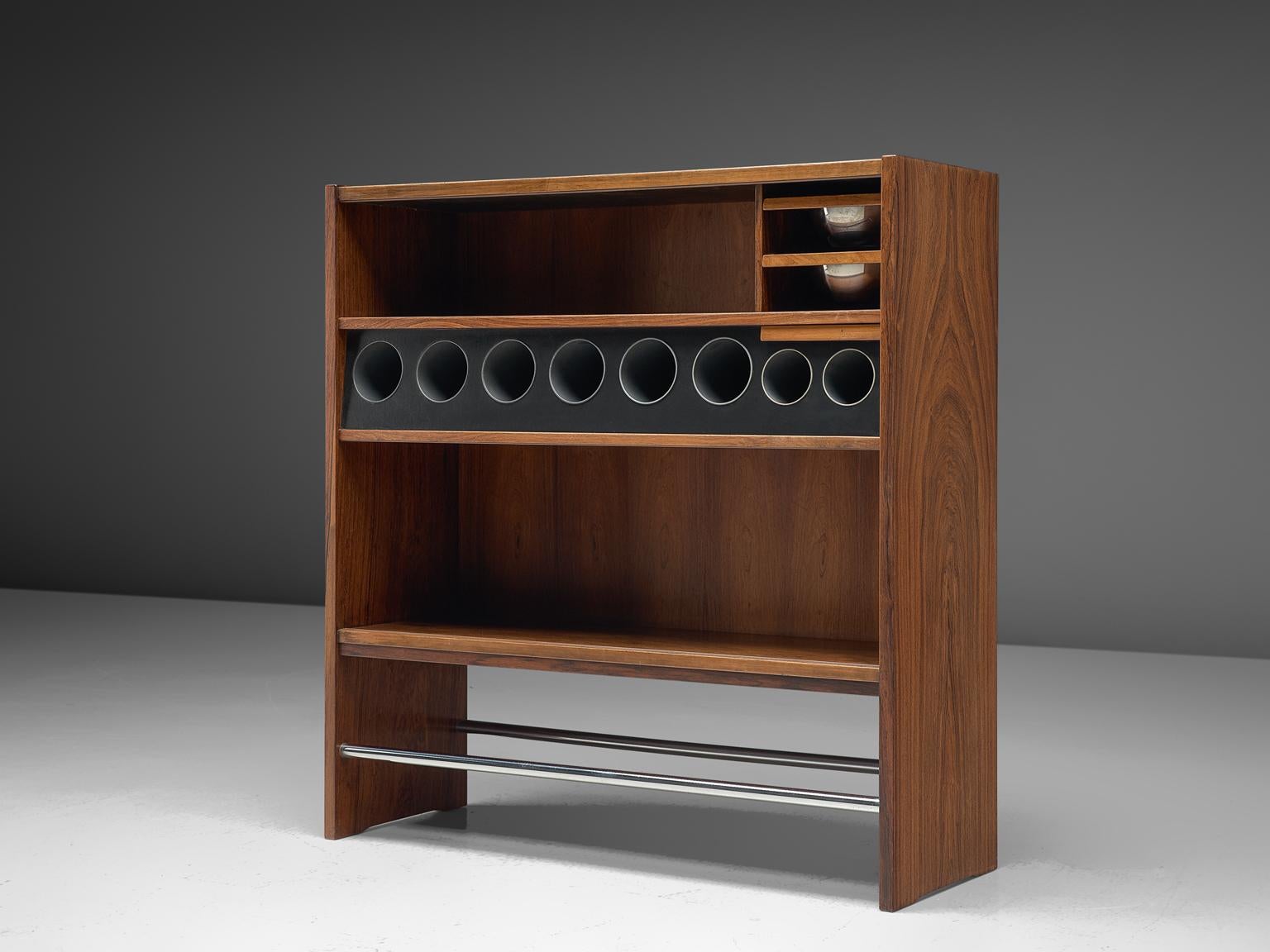 Erik Buch, dry bar, rosewood, Denmark, 1950s.

Elegant Danish dry bar, 1950s. The bar shows a lot of interesting lines and stunning details. In its form the piece is simplistic, yet it is versatile in use. The front is completely covered in a large