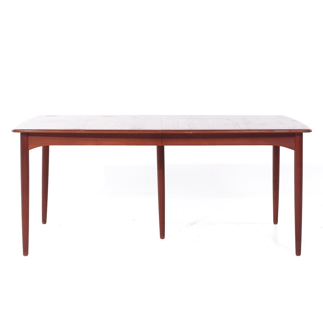 Erik Buch for Povl Dinesen Mid Century Danish Teak Expanding Hidden Leaf Dining Table with 2 Leaves

This table measures: 70.75 wide x 40 deep x 29.5 high, with a chair clearance of 25.25 inches, each hidden leaf measures 22.75 inches, making a