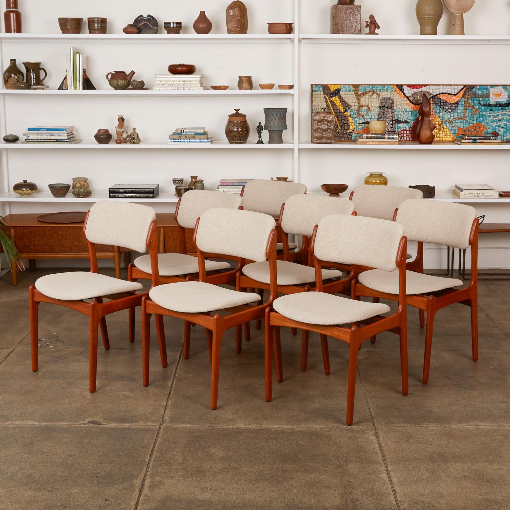 Set of 8 teak dining chairs by Erik Buch for Odense Maskinsnedkeri, Denmark, circa 1956. The set of model 49 dining chairs features two armchairs with sculptured armrests and six side chairs in oiled teak with new oatmeal colored Belgian linen
