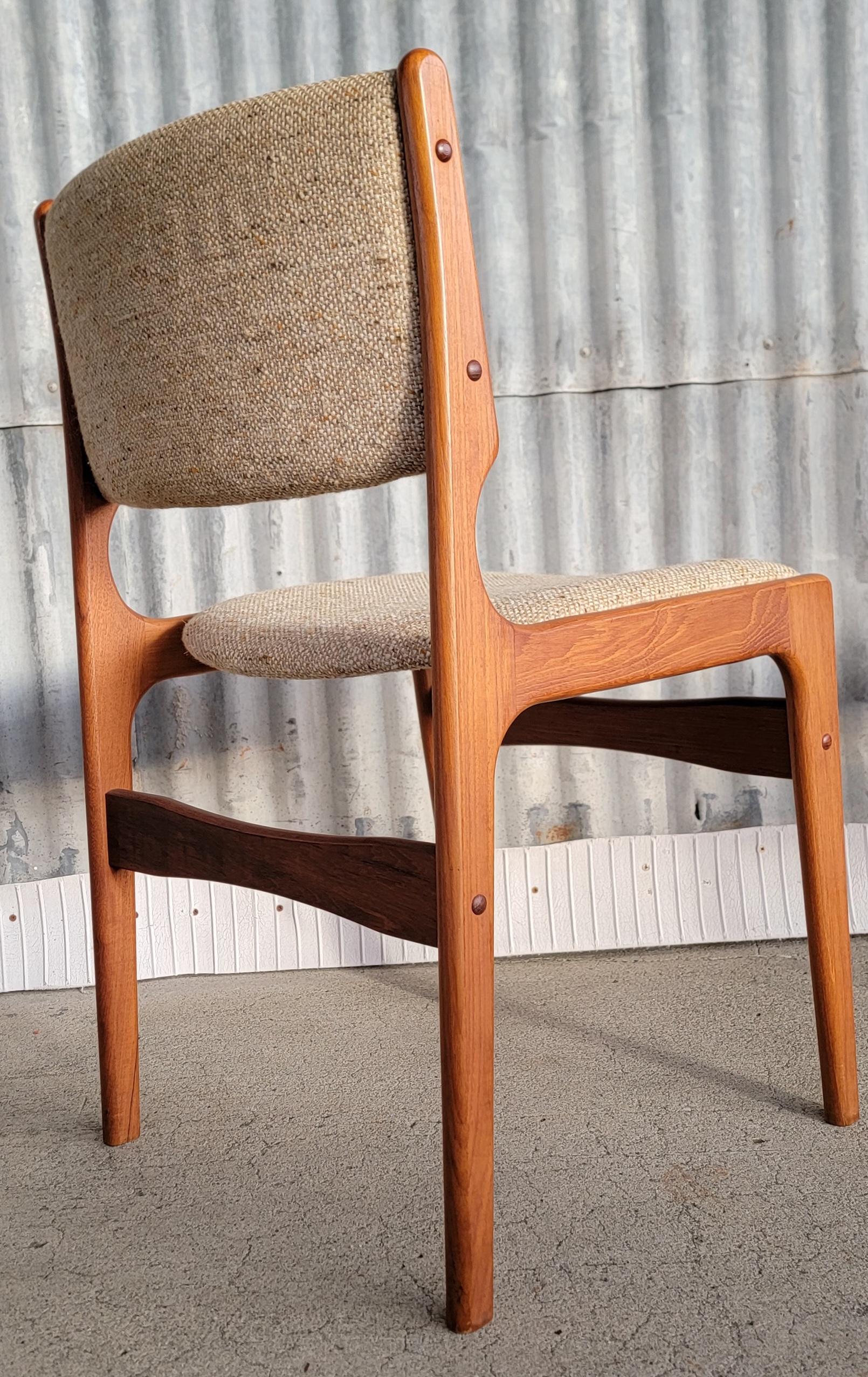 A set of 6 teak Danish Modern dining chairs designed by Erik Buch. Made in Denmark, circa. 1960's. Original finish to solid teak frames is in excellent vintage condition. Nice glow to patina. Original fabric has wear. Notice images of the 2 chairs