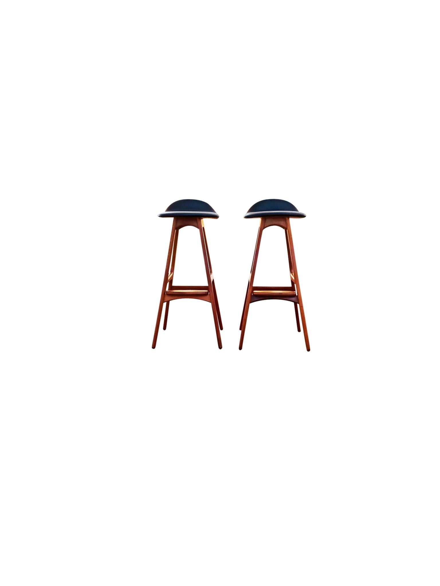 Beautiful pair of bar stools model OD61 by the Danish designer Erik Buck and manufactured by OD Mobler, 1960, A sculptural, elegant and comfortable pair of barstools. Frame is teak, footrest is rosewood, and seat is upholstered in black faux