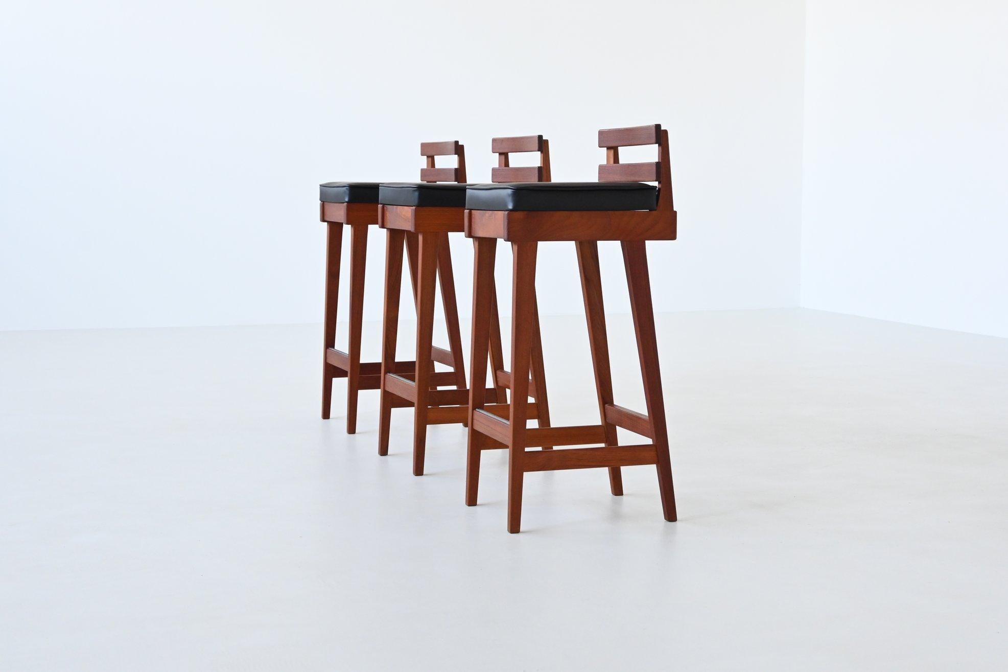 Fantastic set of three bar stools designed by Erik Buck for Dyrlund, Denmark 1960. These bar stools embodies Danish craftsmanship with its simple yet elegant structure. Each stool is crafted from rich teak wood, featuring a straightforward form that
