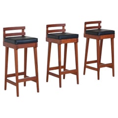 Erik Buck set of three bar stools in teak and leather Dyrlund Denmark 1960