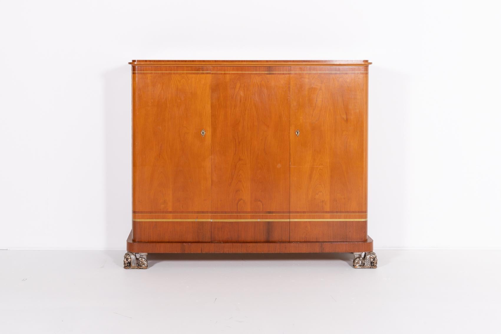 Art deco cabinet by Erik Chambert, Sweden 1920’s. Executed in veneer finish with spectacular lion sphinx front feet. The dresser has 3 doors where behind them you will find five pull-out drawers and shelves.

Condition
Good, age related marks,