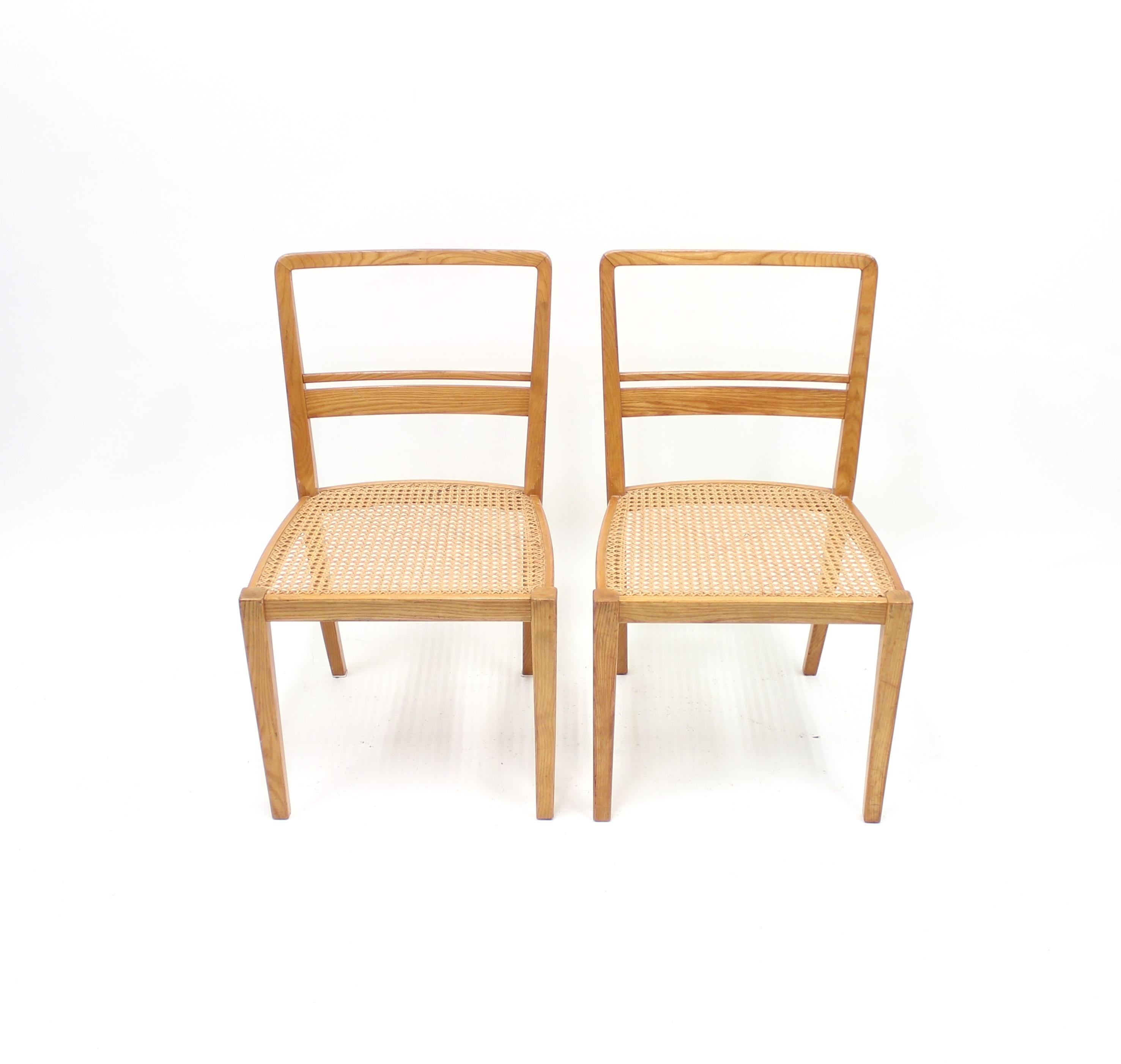 Very rare pair of chairs designed by Erik Chambert in 1937 and produced by his own company AB Chamberts Möbelfabrik. Frame made of ash with cane seat. This exact model was displayed in the International World Exhibition in Paris in 1937 and were