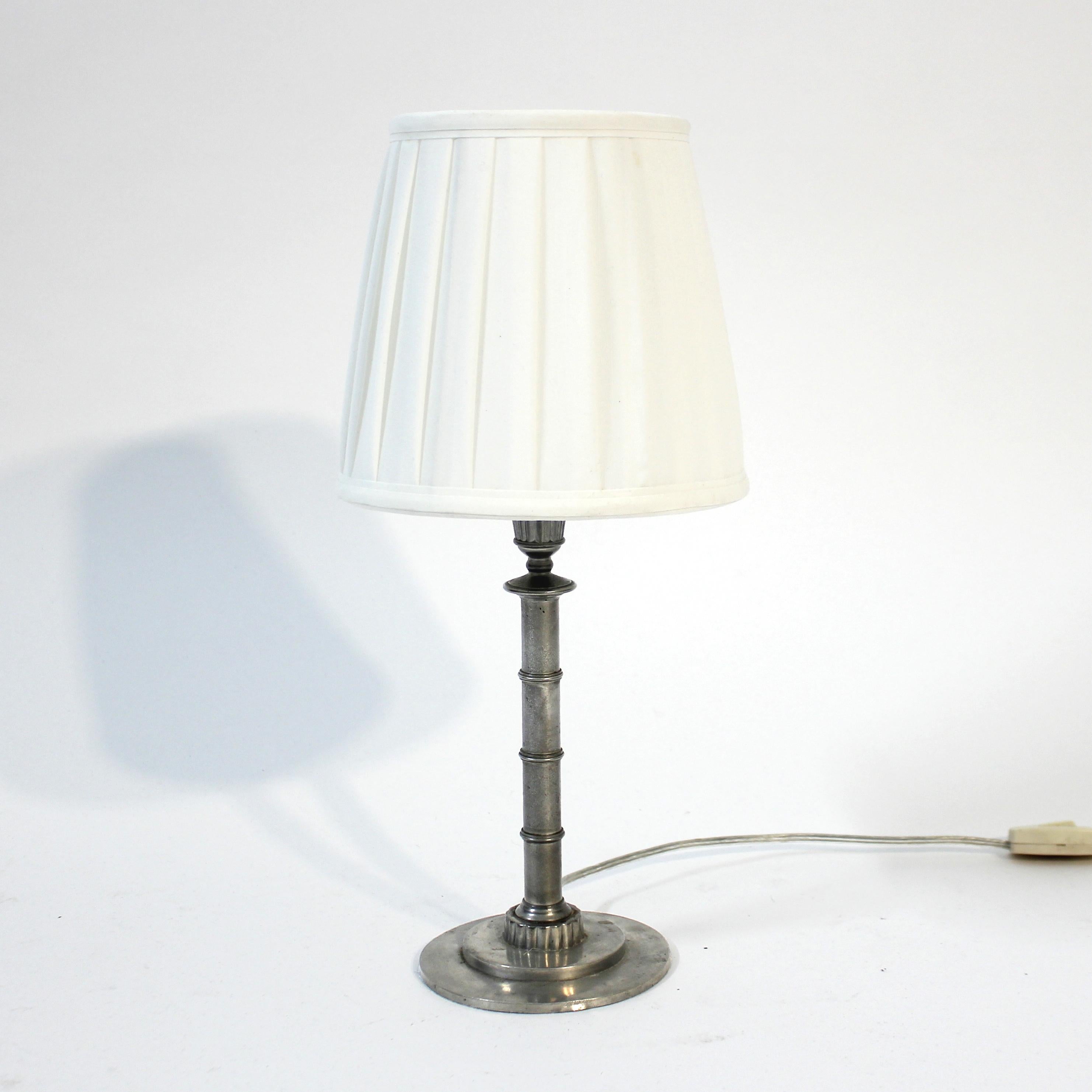 Pewter Art Deco table lamp designed by Danish designer Erik Fleming for Swedish manufacturer Norrhammars bruk, marked N.B. This example is also marked F8 which means made in 1932. Originally a candle holder that sometime over the years have been