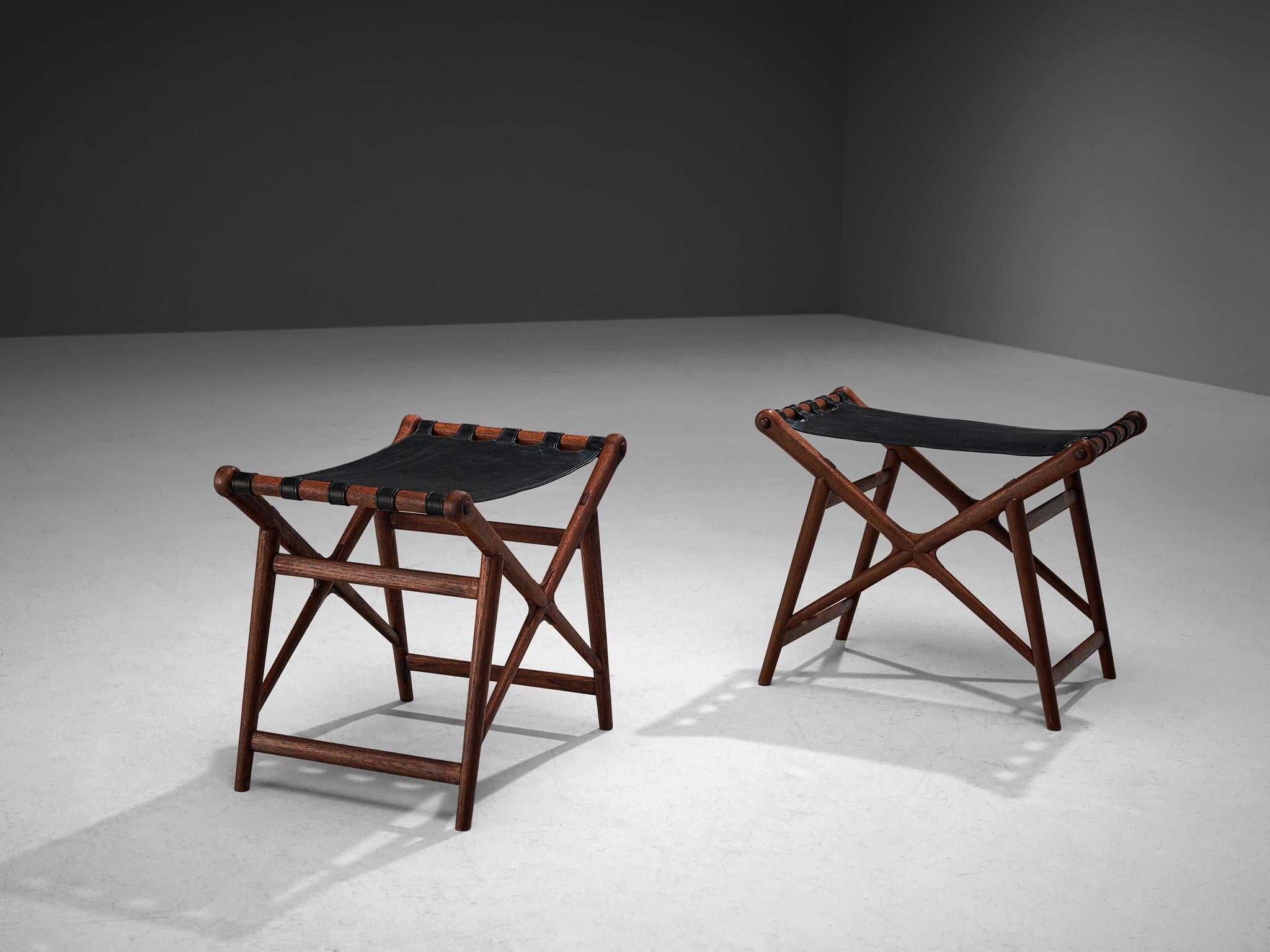 Erik Glemme, stools, teak, leather, Sweden, 1940s. 

Unique pair of custom made stools designed by Erik Glemme. The inspiration for this design was drawn from a folding chair, except these stools cannot be enclosed. Its slender frame is executed