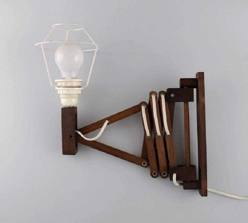 Erik Hansen, Denmark. Scissor lamp in dark oak. 
1960/70's.
Measures: Height: 25 cm.
Length: 30-67 cm.
In excellent condition.