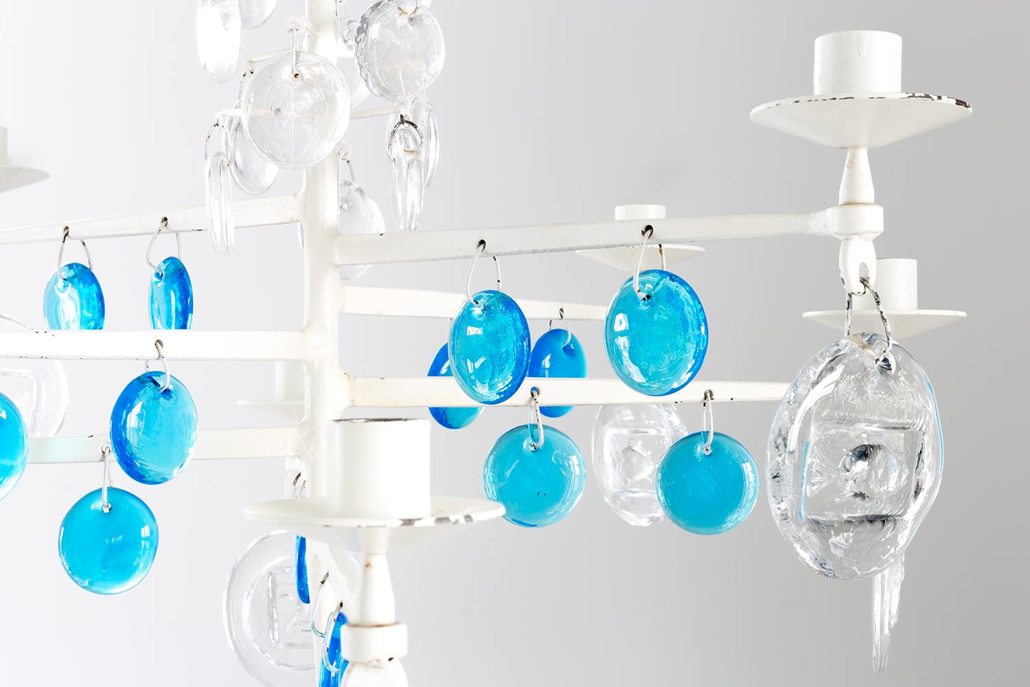 Chandelier with an iron frame made using the wrought iron technique of forming by hammerwork, hand-blown glass and glass ornaments.

This one has a rare frame painted white and turquoise ornaments, manufactured in the late 1960s. Four iron hooks are