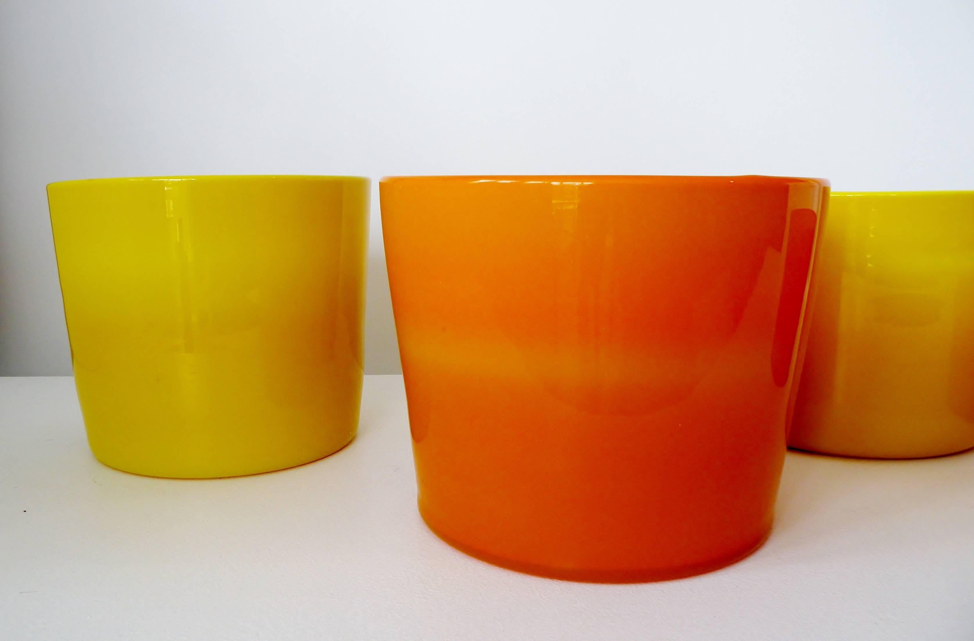 A collection of four art glass vases or planters designed by Erik Hoglund in the 1960s for Boda Glassworks Sweden. 

Orange pair approximate:
small 6.5