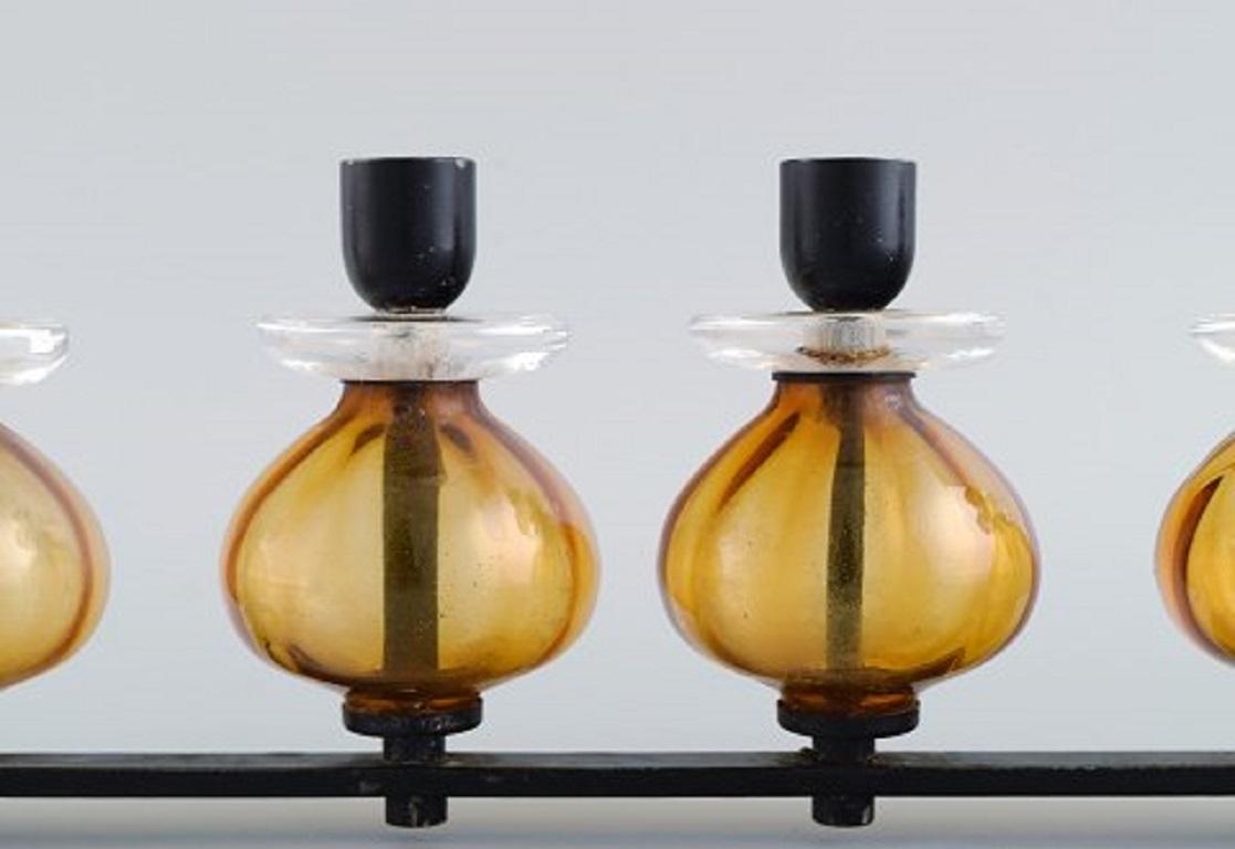Erik Höglund for Kosta Boda. Candlestick in cast iron and mouth-blown art glass. 1960s / 70s.
Measures: 35 x 13 cm.
In excellent condition.