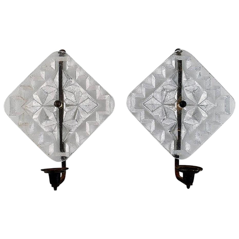 Erik Höglund for Kosta Boda, Two Wall Candleholders in Clear Art Glass and Iron