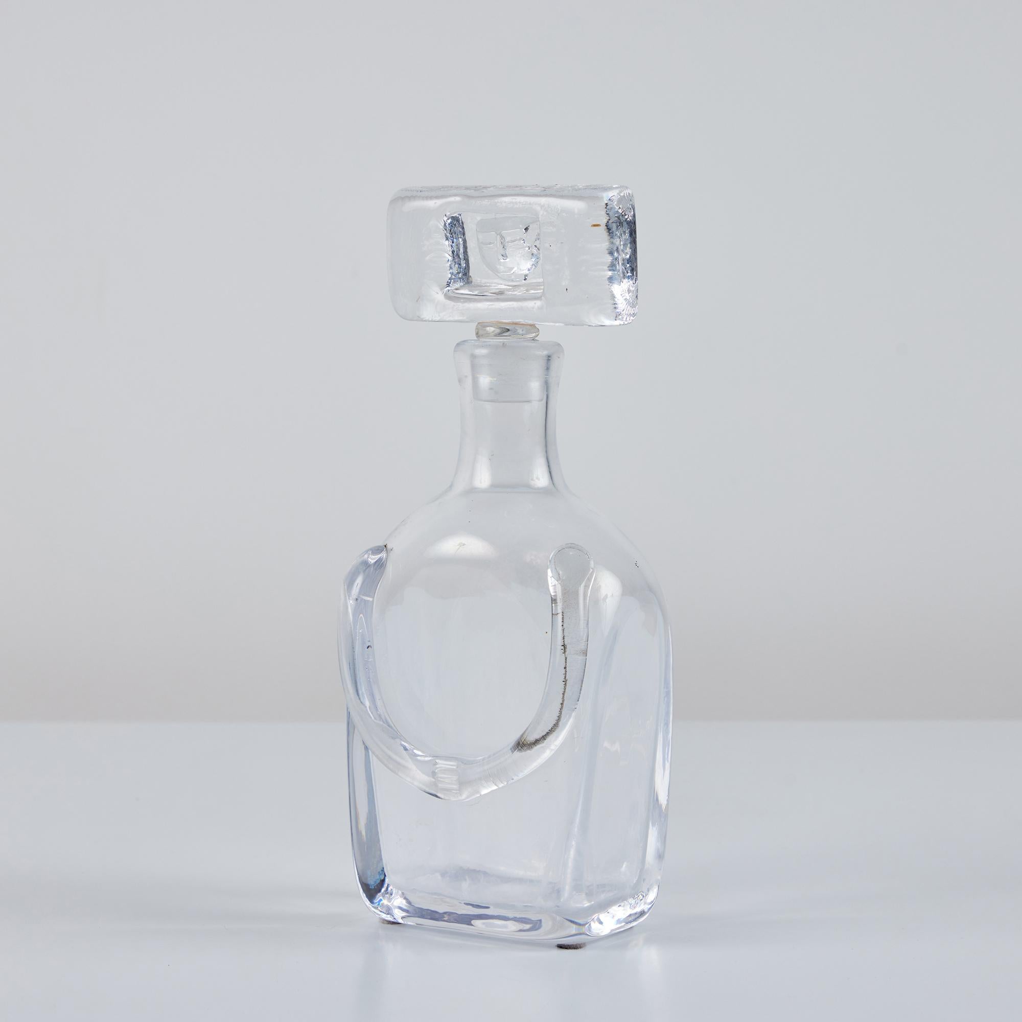 People decanter by Erik Hoglund for Kosta Boda, c.1950s, Sweden. This piece features a clear blown glass vessel and glass stopper with Hoglund's signature glass 
