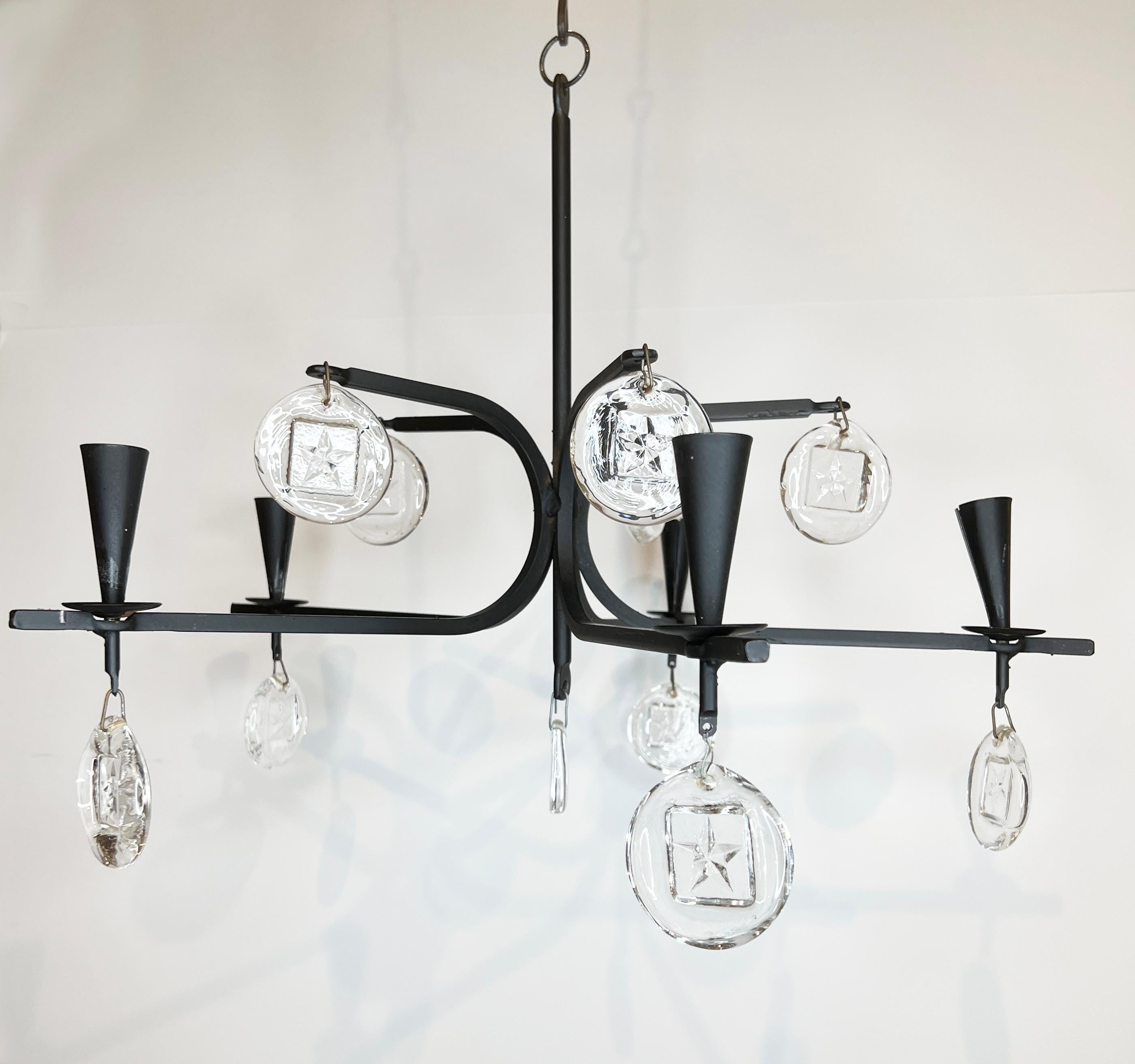 Petite Erik Hoglund Style Chandelier with 5 arms. Glass discs reflect light making it a distinctive option in a powder room or outdoor space.
The body of the chandelier measures 19″ Diameter by 14″ High. Then, there are 6 – 5″ extensions.
It is not