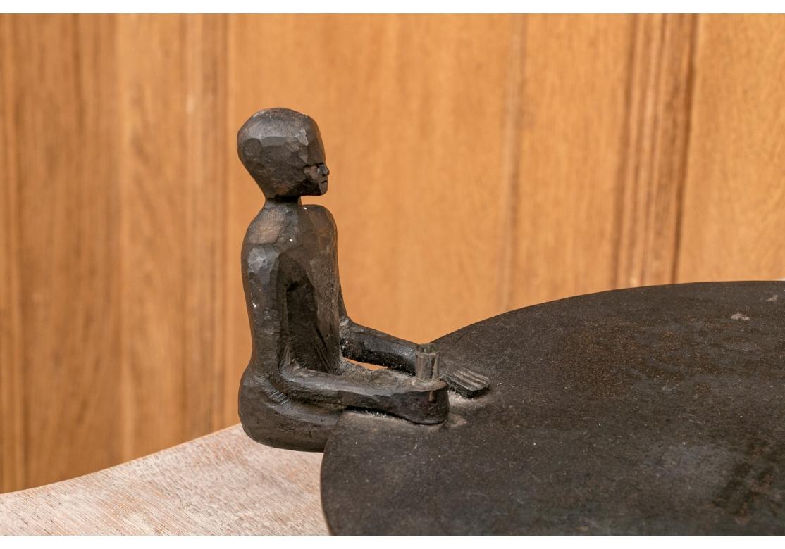A Bronze sculpture by the celebrated multi-disciplinary Mid Century Swedish artist. Exhibiting three figures, one female and two male, seated at large round table with drink glasses in hand and two plates on the table. Marked on bottom, stamped Form