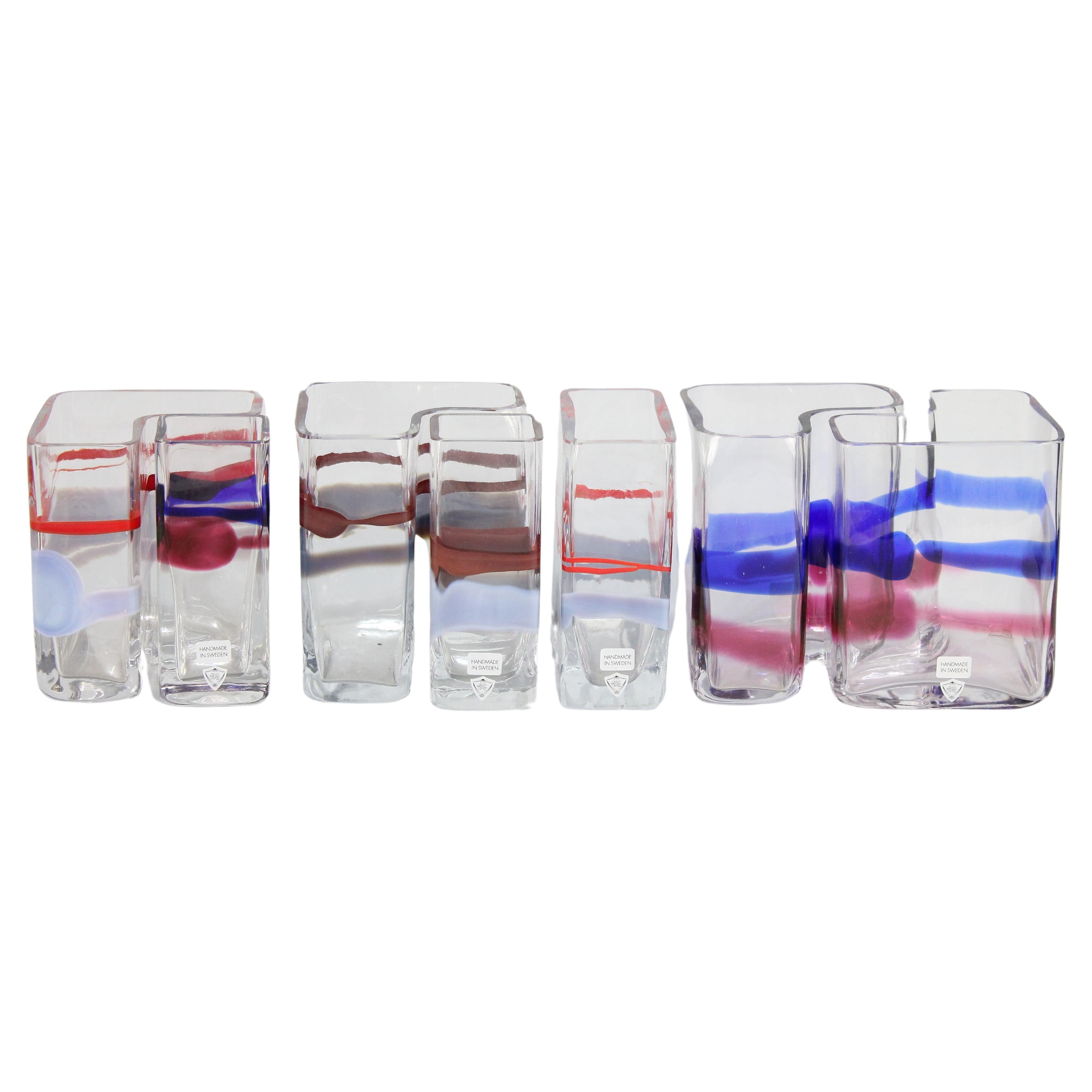 Wonderful set of seven modernist so called Puzzle Vases in glass designed 1986 by famous Swedish glassmaker Erik Höglund (1932-1998).

You can set up these vases in so many different variations. 
All hand blown and with different colors. Height 15cm