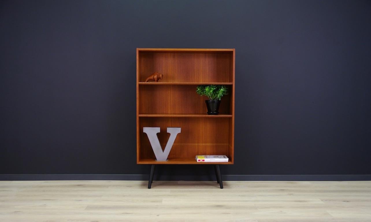 Classic bookcase of the 1960s-1970s. Beautiful straight line designed by a leading Danish designer Erik Jensen. Veneered with teak. Boards height adjustable. Shelf in good condition with visible signs of wear (small scratches and dings are