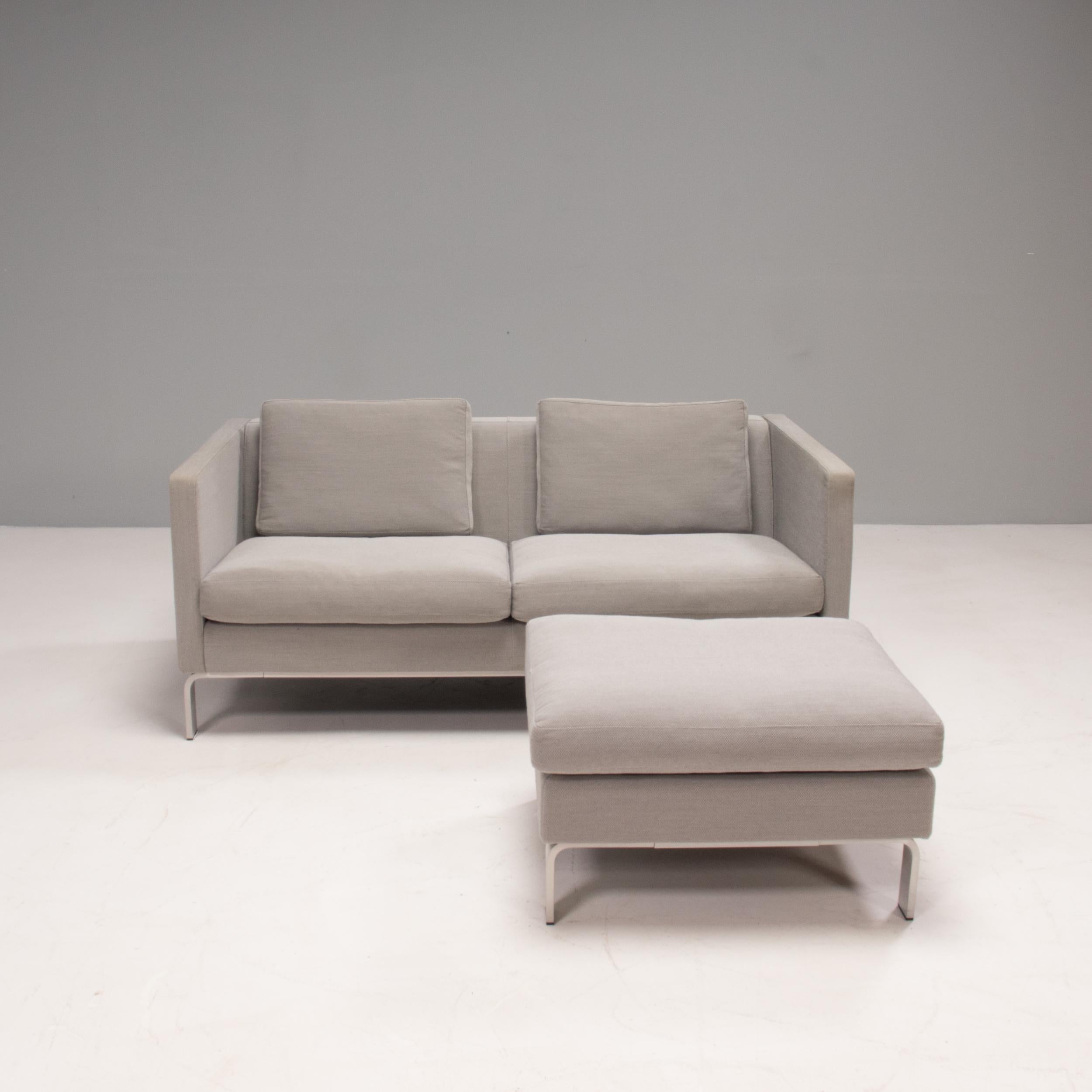 Designed and manufactured by Erik Jørgensen this sofa and footstool is a timeless example of high quality Danish design.

The slimline frame and sleek Silhouette is contrasted by the curved lines of the chrome feet.

Fully upholstered in grey