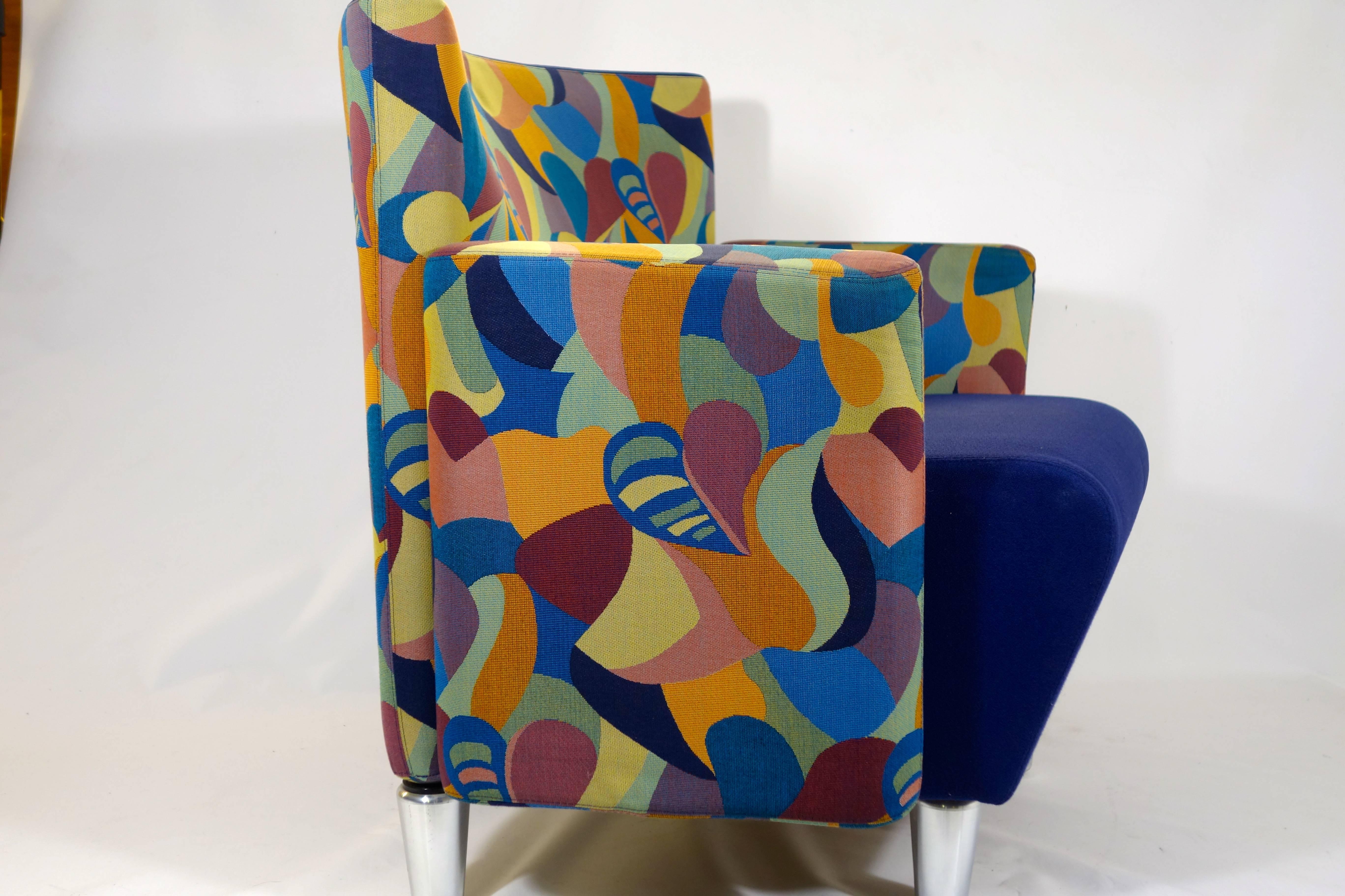 Very rare pair of Postmodern lounge chairs by Danish manufacturer Erik Jørgensen made in 1997. 
These very solid and heavy chairs sit on four chrome feet. 
They are upholstered with two different fabrics: blue fabric for the seat and a cartoon like