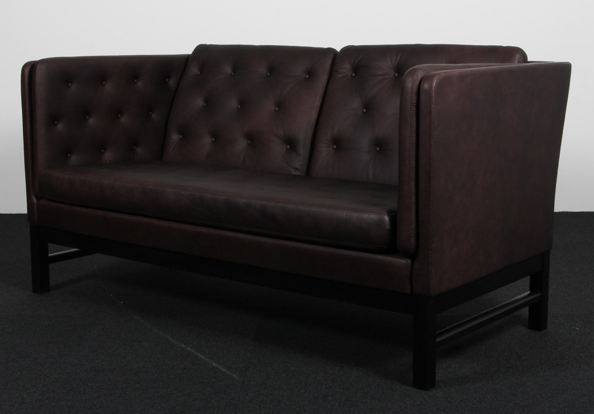 Erik Jørgensen two-seat sofa new upholstered with mokka aniline leather.

Frame of black painted beech.

Model EJ 315/2, made by Erik Jørgensen.