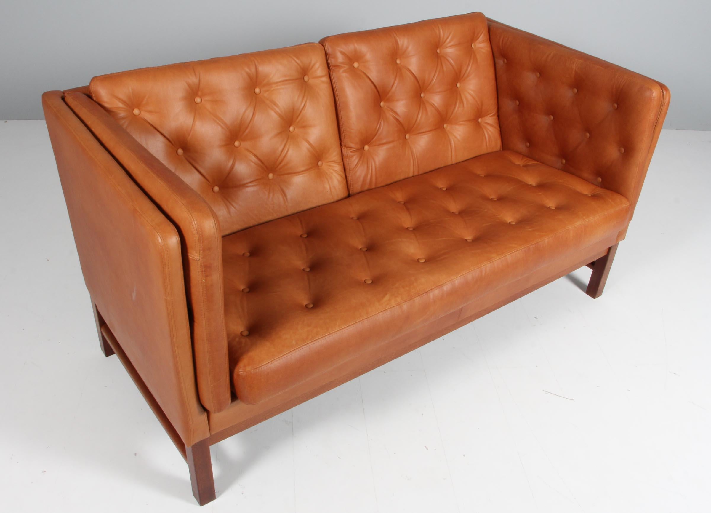 Erik Jørgensen two-seat sofa, new upholstered with cognac vintage aniline leather.

Base in mahogany

Model 315 / 2, made by Erik Jørgensen.