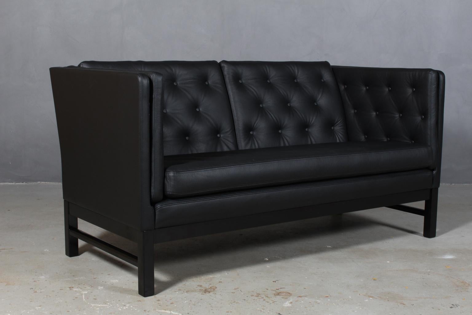 Erik Jørgensen two-seat sofa, new upholstered with black leather. 

Base in black laquered wood.

Model 315 / 2, made by Erik Jørgensen.