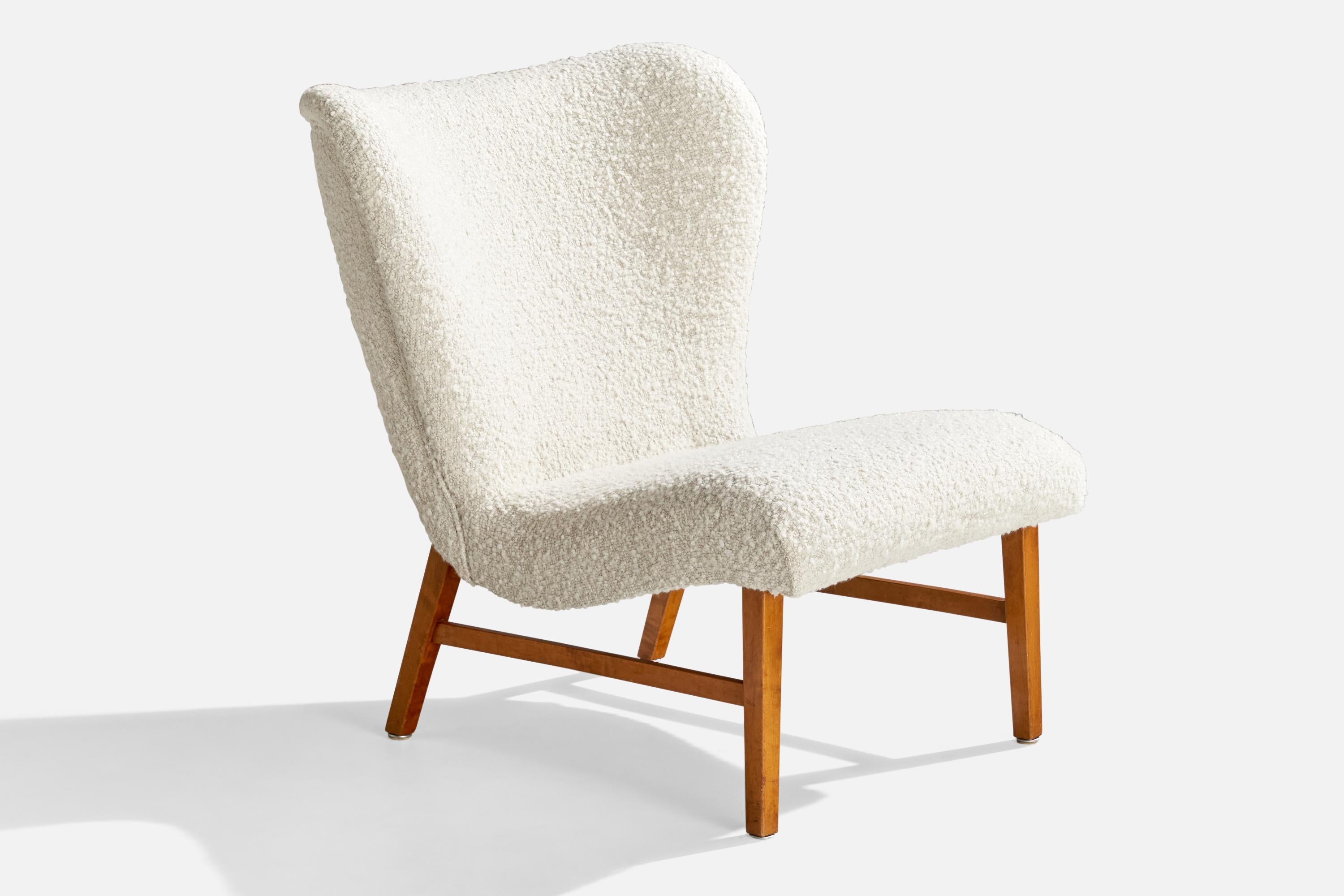 A white bouclé fabric and birch slipper lounge chair attributed to Erik Karlén for Firma Rumsinteriör, Sweden, c. 1950s.

Seat Height: 16.75