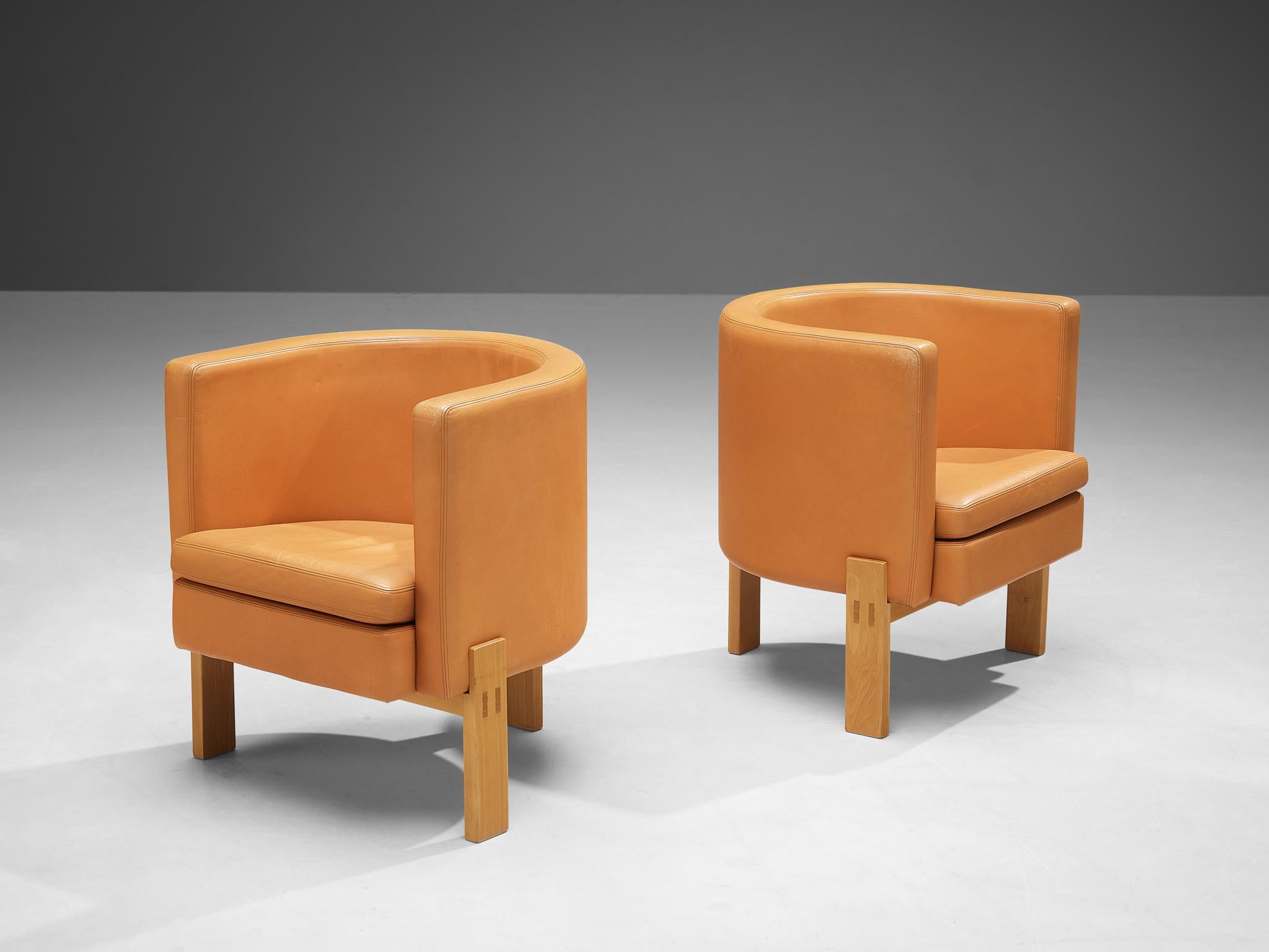 Erik Karlström for Källemo, pair of armchairs model 'Club', leather, beech, Sweden, 1960s. 

The construction of the 'barrel' seat embodies characterises of the Art Deco period. Yet, the wooden frame is typically constructed in a Scandinavian