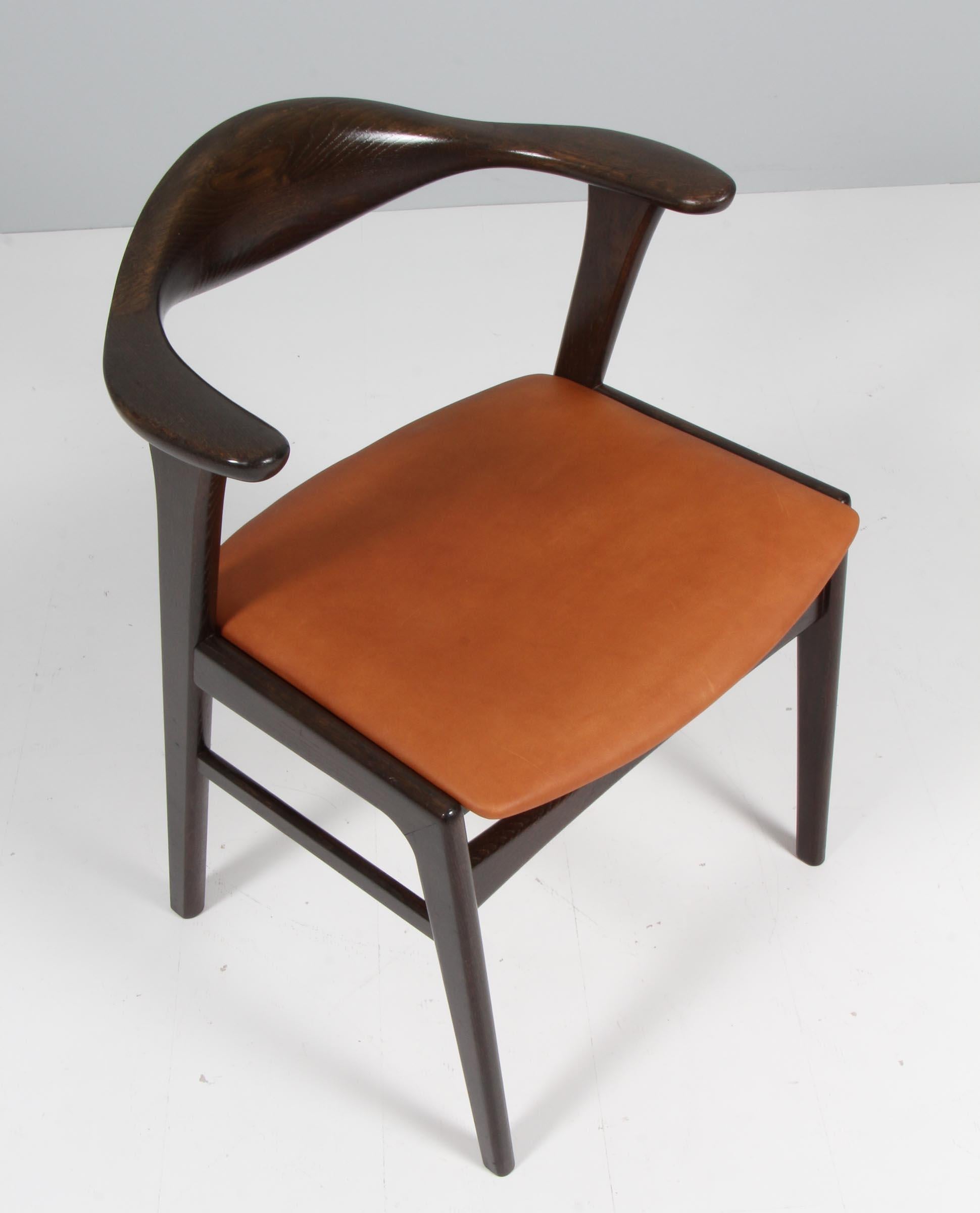 Erik Kirkegaard armchair in smoked oak.

Seat new upholstered with vintage anilin.

Made by Høng Stolefabrik.