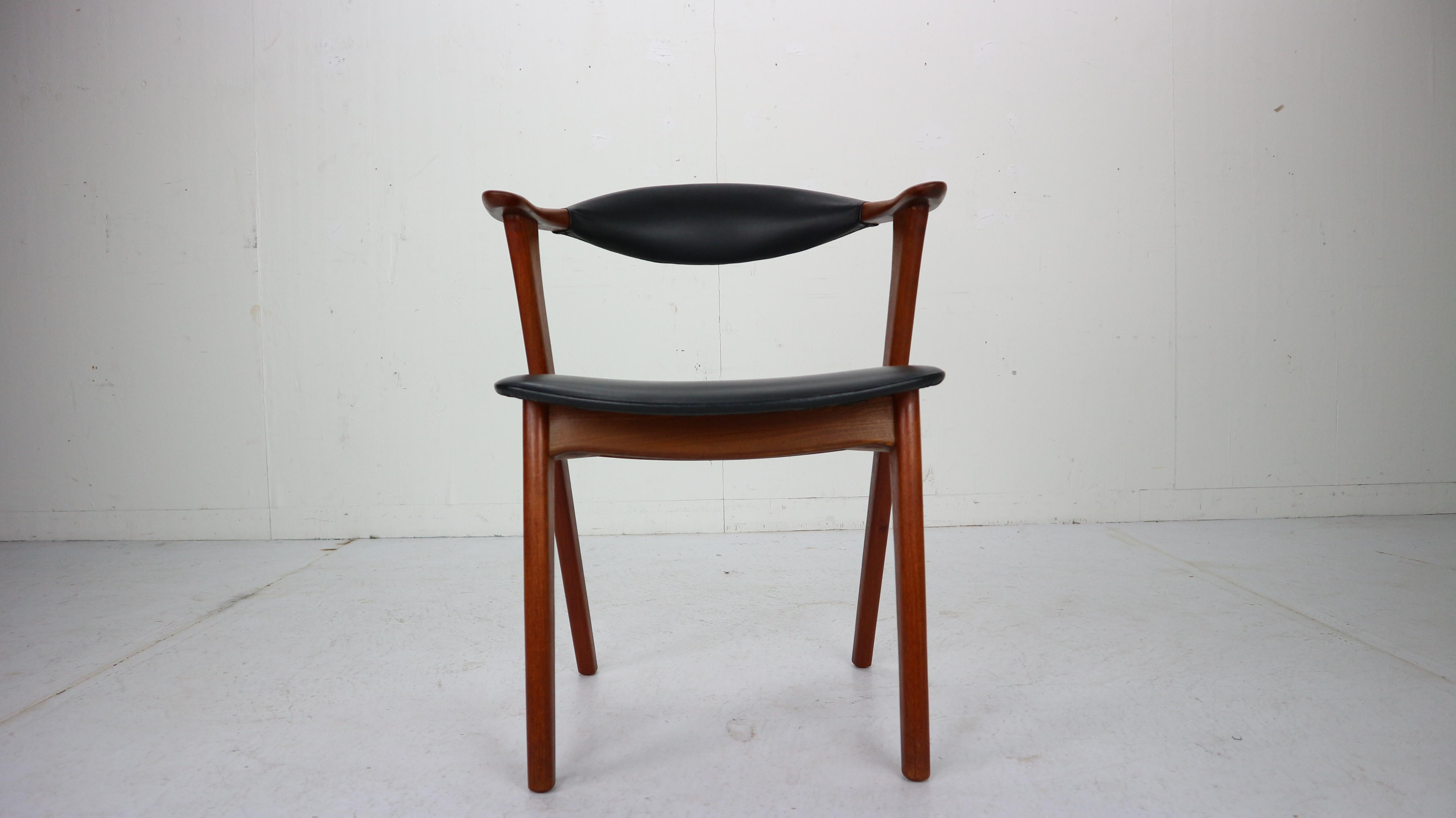 Armchair designed by Erik Kirkegaard and manufactured by Høng Stolefabrik in 1960s, Denmark. 
Teak solid wood frame and armrests. Original black faux leather seating in a good vintage condition.
Chair is originally marked.