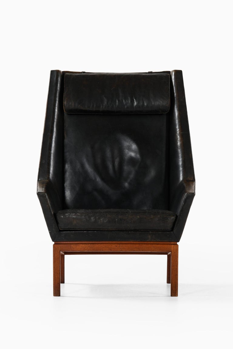 Rare highbacked easy chair designed by Erik Kolling Andersen. Produced by cabinetmaker Peder Pedersen in Denmark.