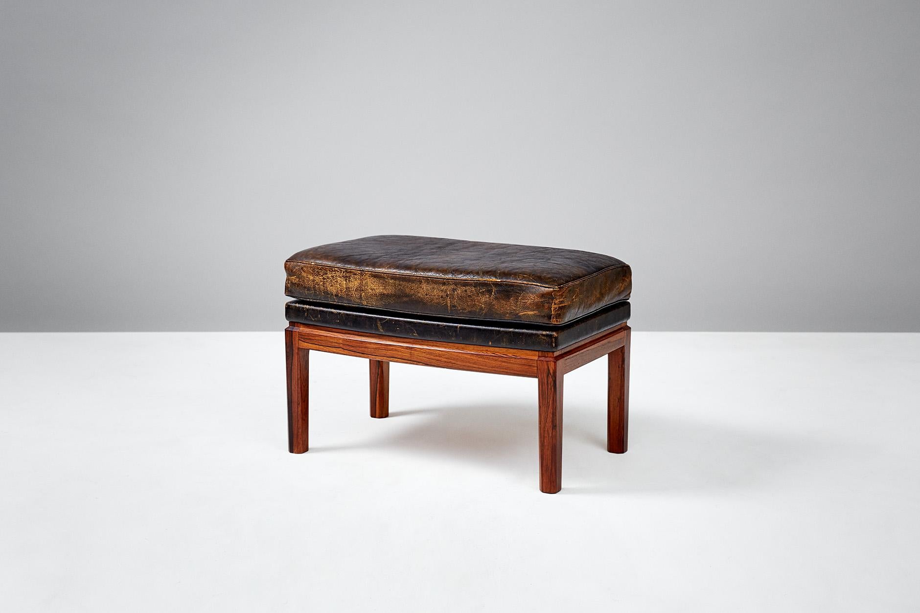 Erik Kolling Andersen

Leather ottoman, 1953.

Patinated leather ottoman on curved Brazilian rosewood frame. Produced by master Danish cabinetmaker Peder Pedersen. 

Model first presented at The Copenhagen Cabinetmakers' Guild Exhibition at