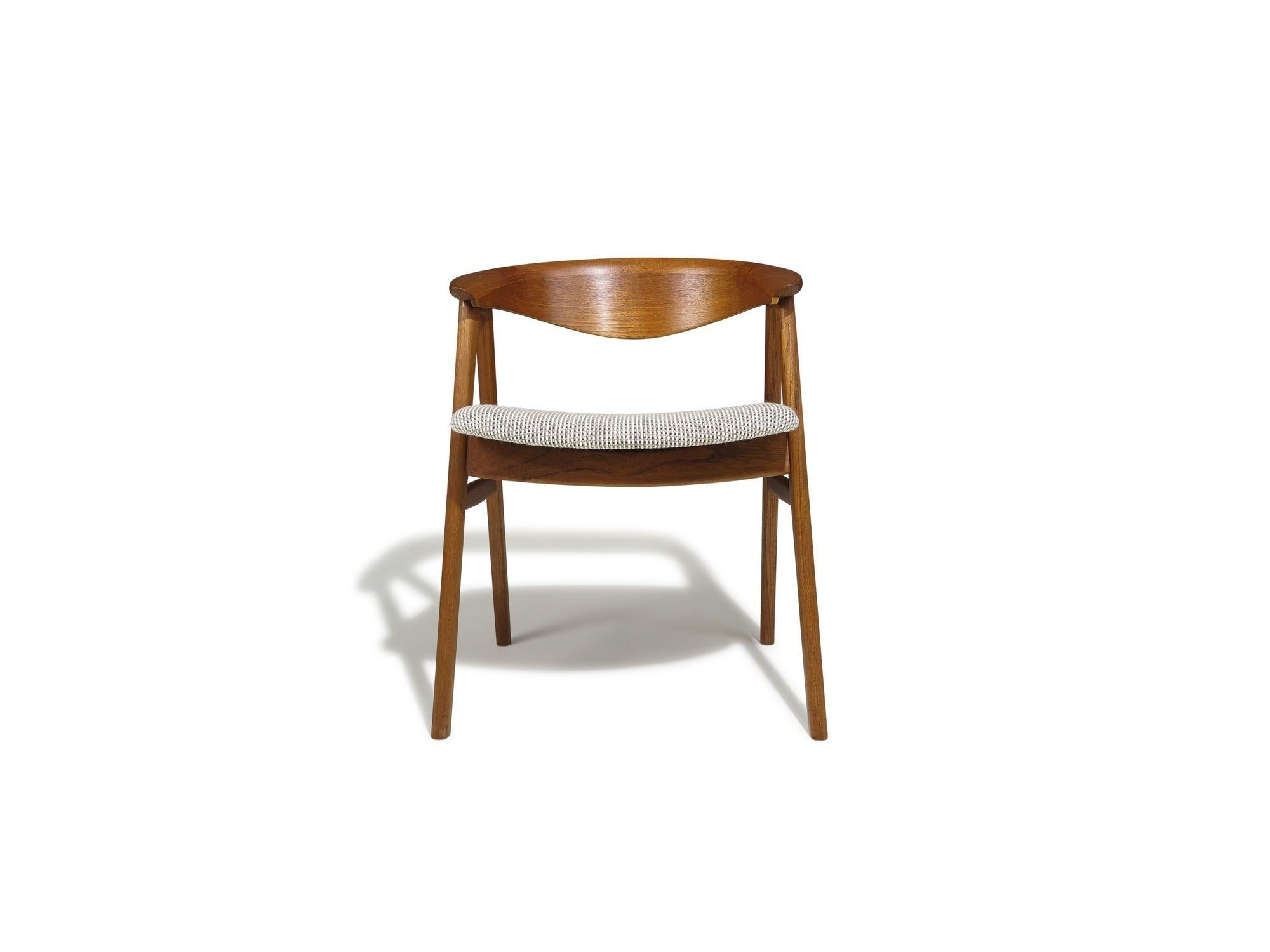 Danish Midcentury teak dining chairs designed by Erik Kirkegaard, Model 52, crafted of teak with sculpted backrest on a solid teak frame with newly upholstered seats . Excellent condition with minor signs of age-appropriate use.
Measurements 
W