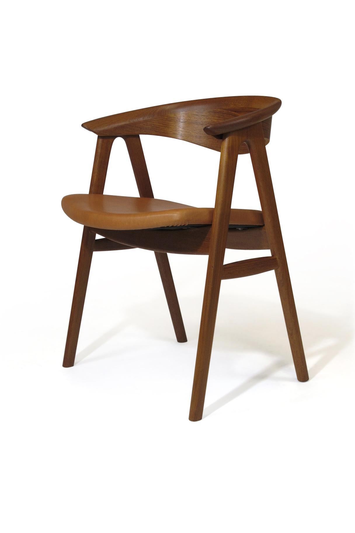 Danish midcentury teak dining chairs designed by Erik Kirkegaard, model 52, crafted of teak with sculpted backrest on a sold teak frame with newly upholstered in saddle leather. Fully restored and in an excellent condition with minor signs of age