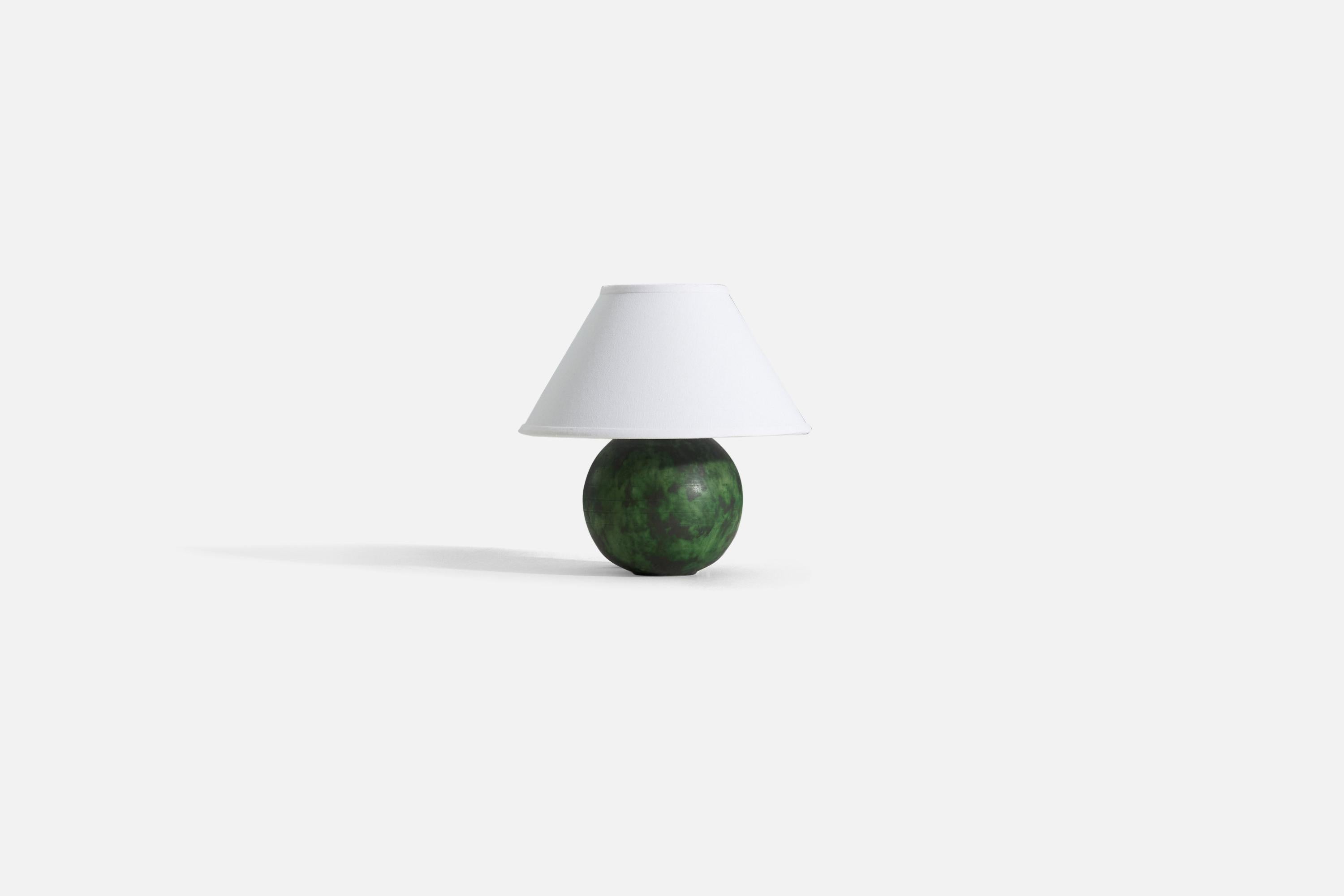A round, green table lamp in glazed earthenware and brass, designed by Erik Mornils for Nittsjö, Sweden 1940s.

Stated dimensions exclude the lampshade. Height includes socket. Sold without lampshade. 

Dimensions of Lamp (inches) : 10 x 6.5 x