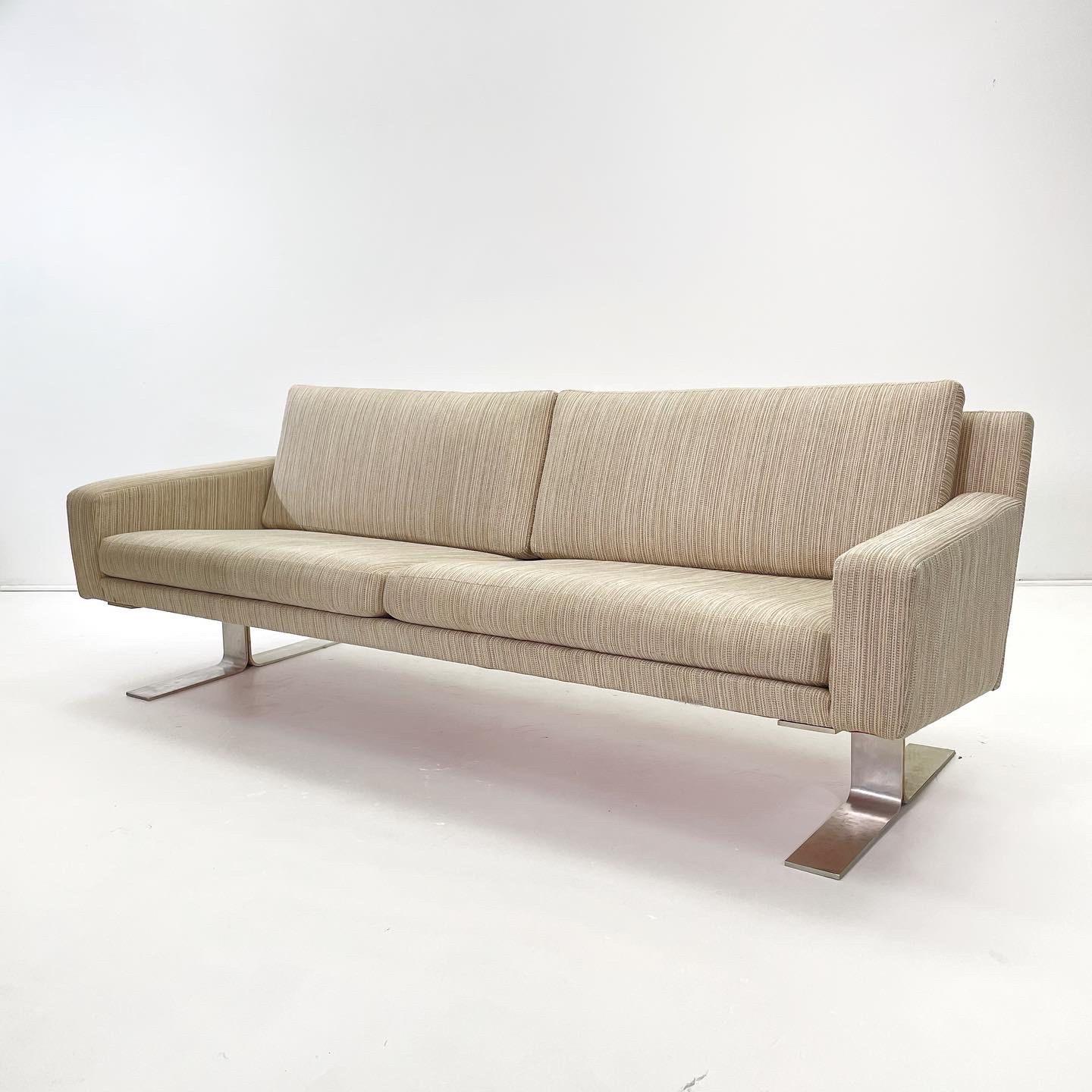 Sofa by Danish designer Erik Ole Jorgensen for DUX, Sweden c. 1970’s. This sleek, straight lined Scandinavian modern sofa rests on a pair of thick polished aluminum curved legs that make a statement for any modern living area.