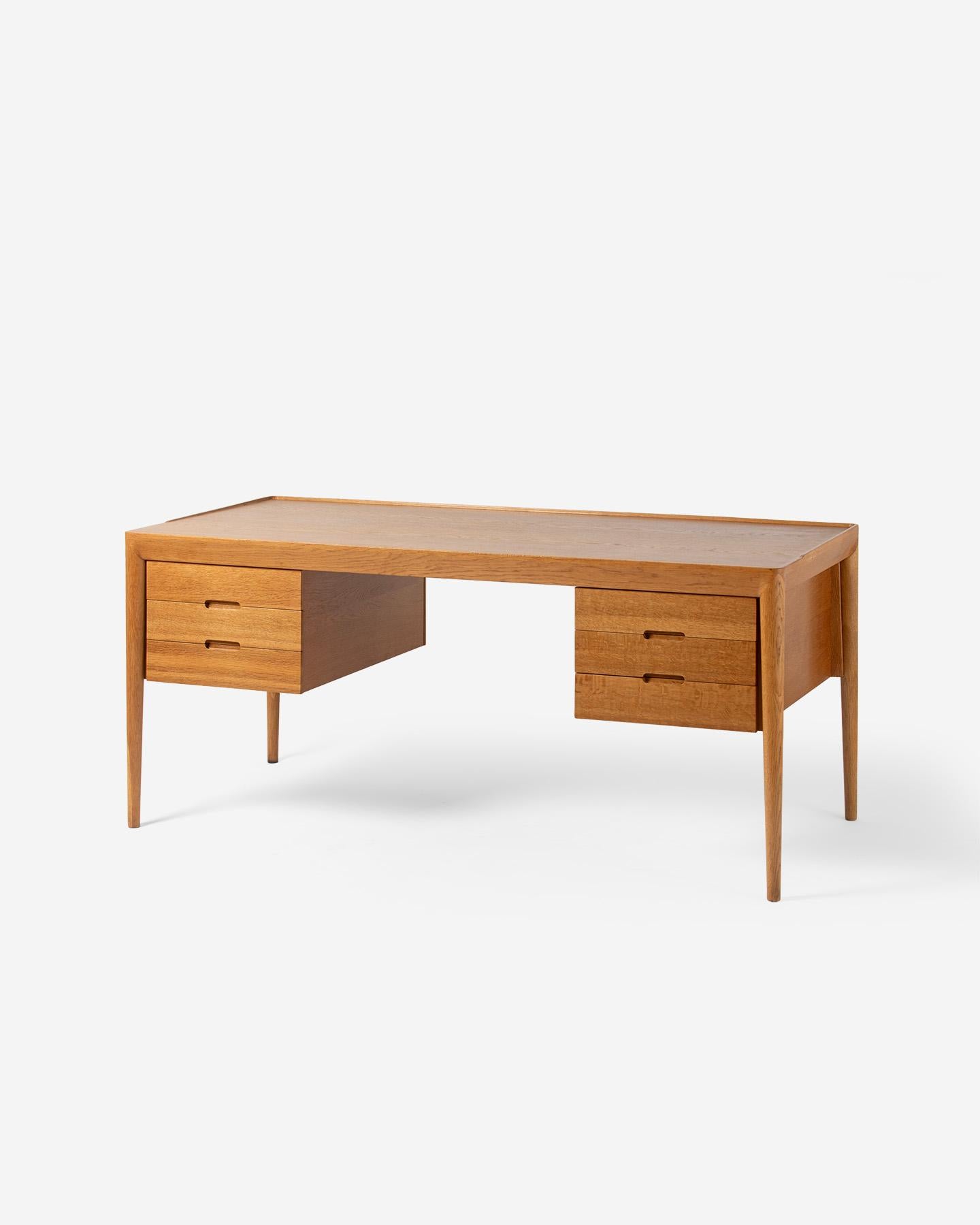 Erik Risager Hansen - Model 66 Writing Desk

This exquisitely made desk from Severin Hansen Jnr. under his full name of Erik Risager-Hansen was produced by Haslev Mobelsnedkeri in the town of Haslev, Denmark, circa 1960.  The top is oak veneer and